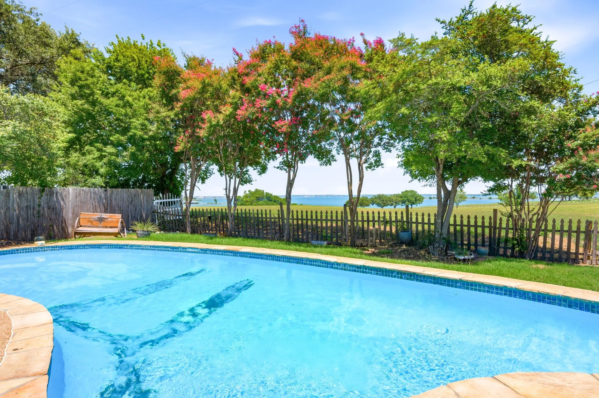 In-ground swimming pool with flagstone coping