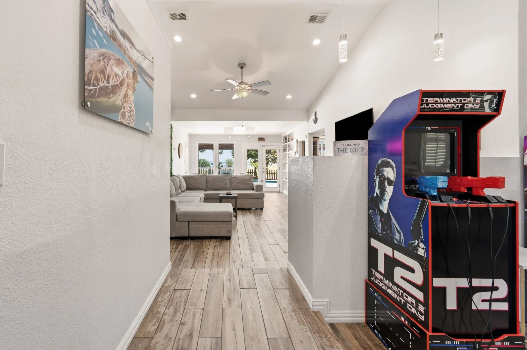 Open-concept living area featuring wood-finish flooring, recessed lighting, and a ceiling fan