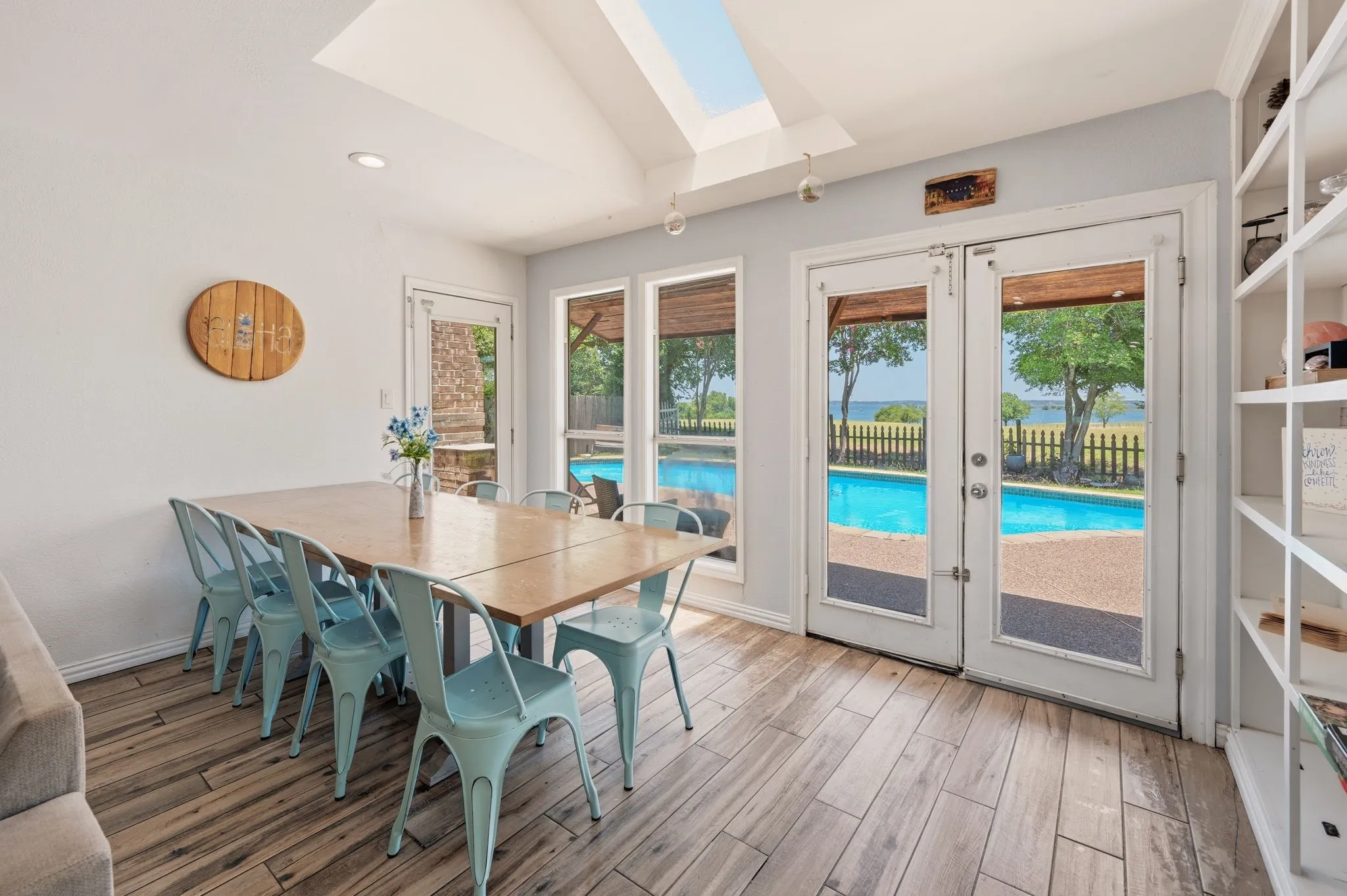 Interior space featuring wood-finish flooring, a skylight, and built-in shelving