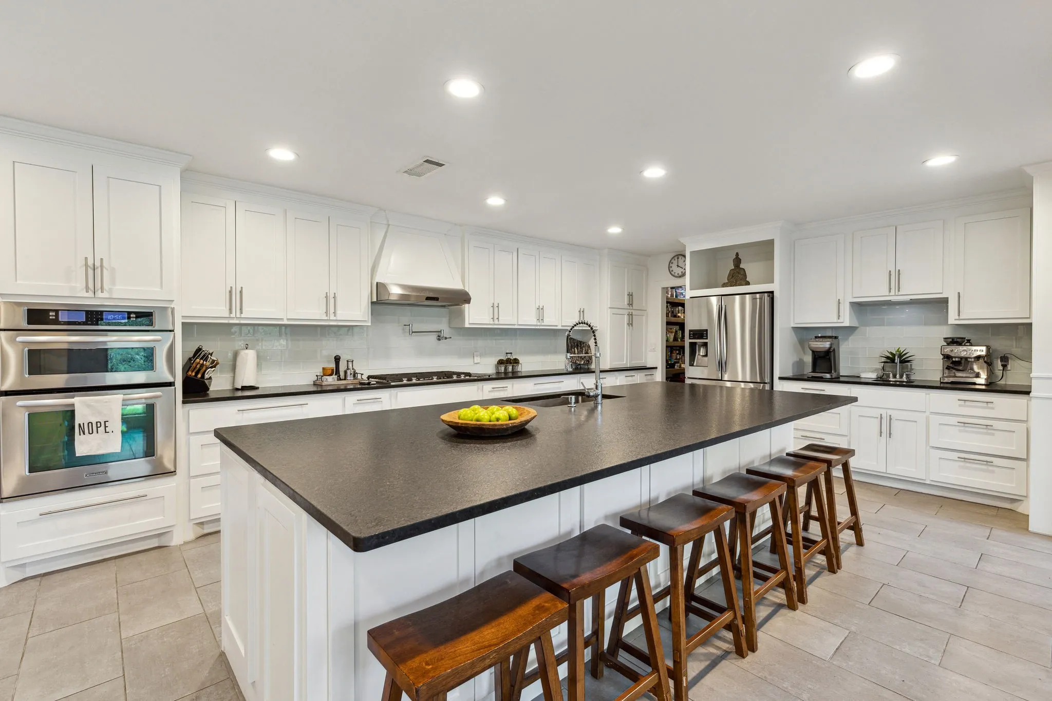 Kitchen featuring custom cabinets with plenty of storage and sitting space for entertainment