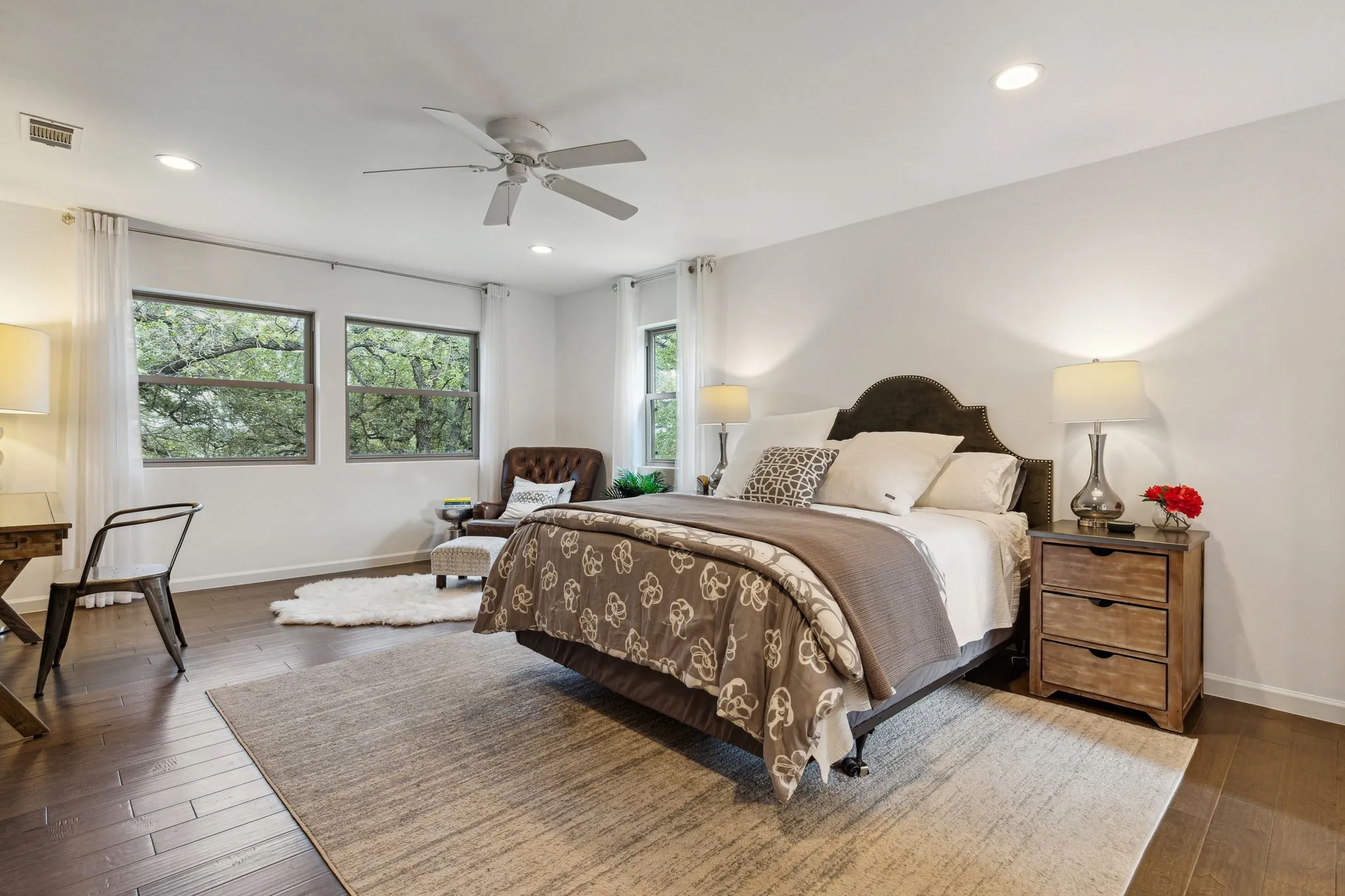 Large master bedroom with sitting area and beautiful views of the park-like gardens