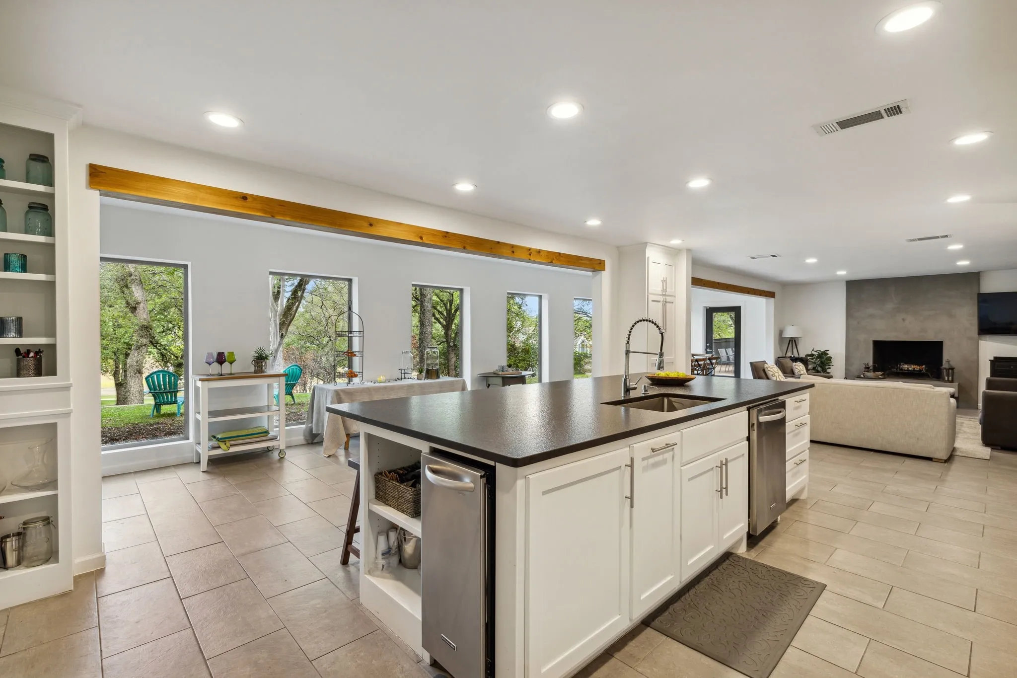 Chef's kitchen with open layout features a very large eat-in island, custom cabinets, and a wealth of natural light
