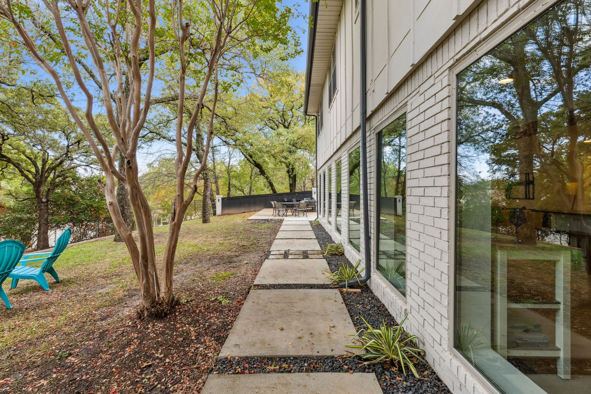 Hardscaped walkway connects downstairs outdoor living areas