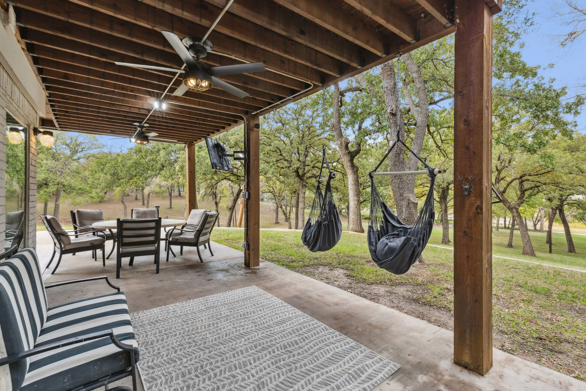 Covered porch right outside of the kitchen area provides shade from the sun and beautfiul veiws of the land and water