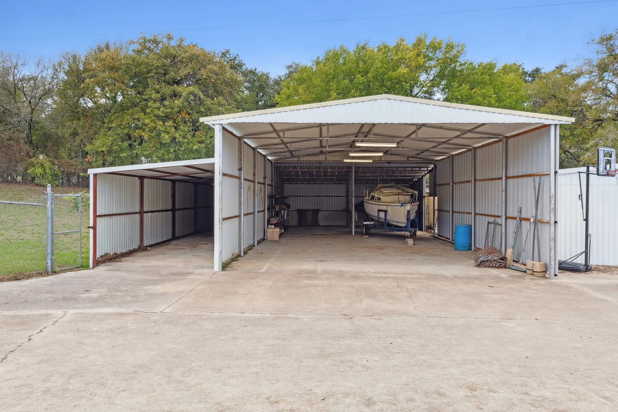 View of parking / parking lot featuring a tall carport perfect to park RV and/or boat