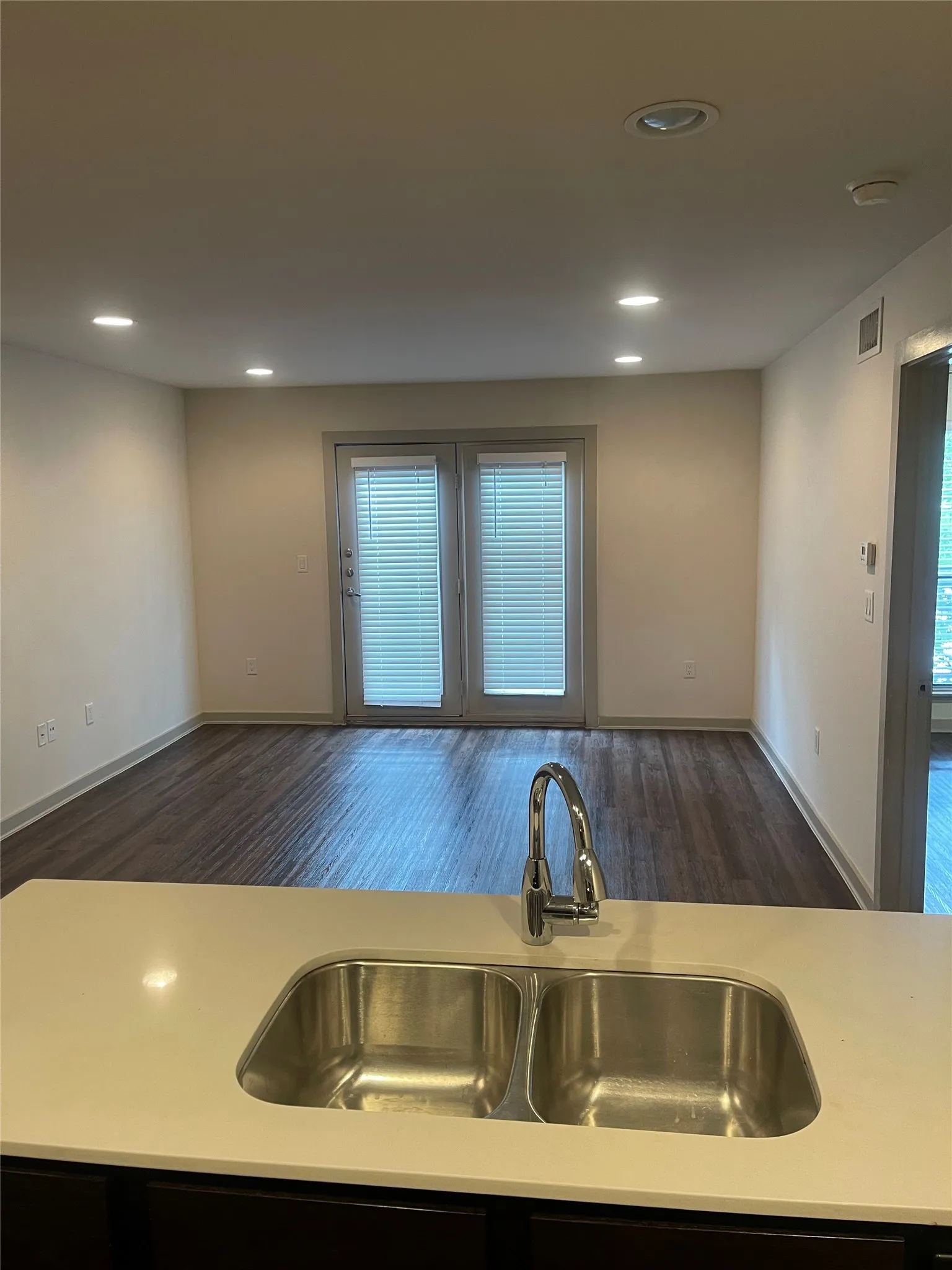 Kitchen island with integrated double-basin stainless steel sink and gooseneck faucet