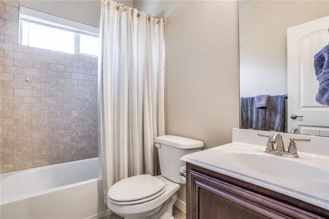 Bathroom featuring a white tub, subway tile surround, and an upper transom window