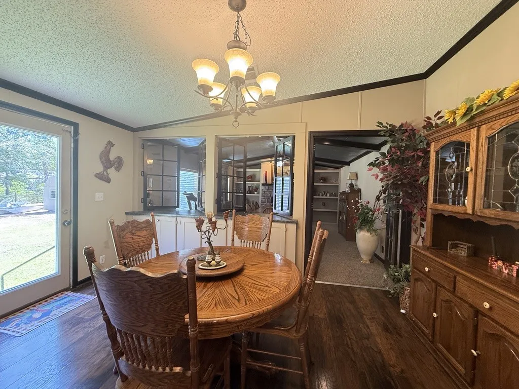 Dining area featuring wood-finish flooring and a ceiling-mounted chandelier