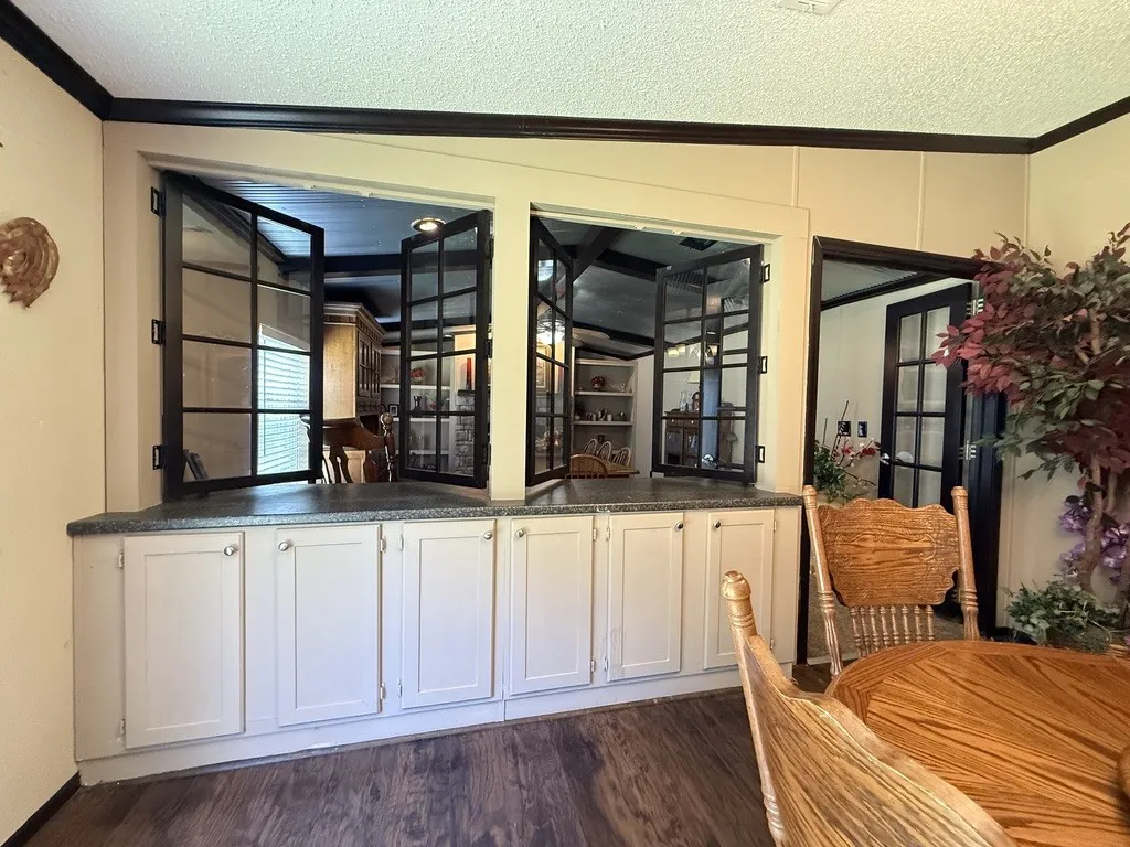 Built-in cabinetry with light-colored doors and neutral countertops