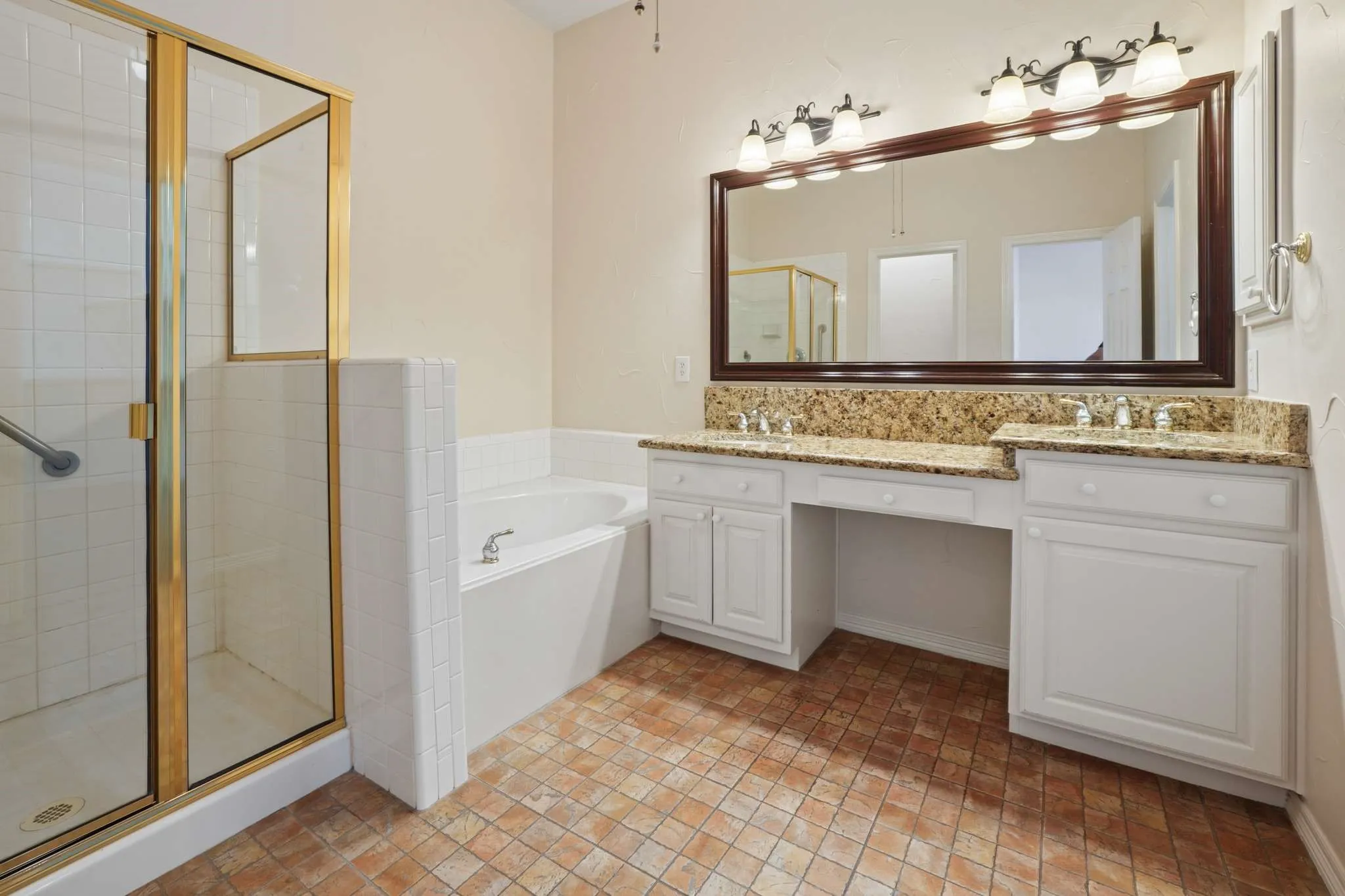 Primary bathroom has double vanities, separate sink and granite countertops.