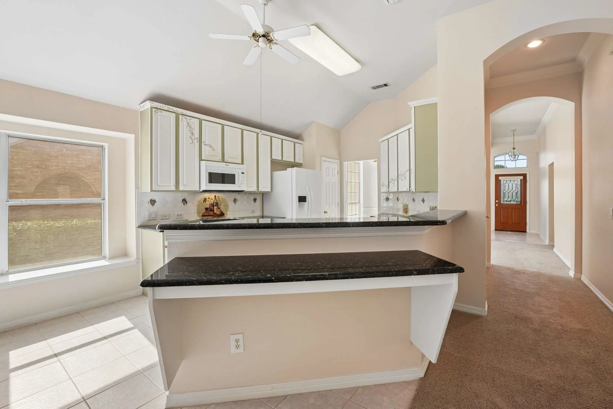 Custom breakfast bar adjoining the living and kitchen for additional serving space.