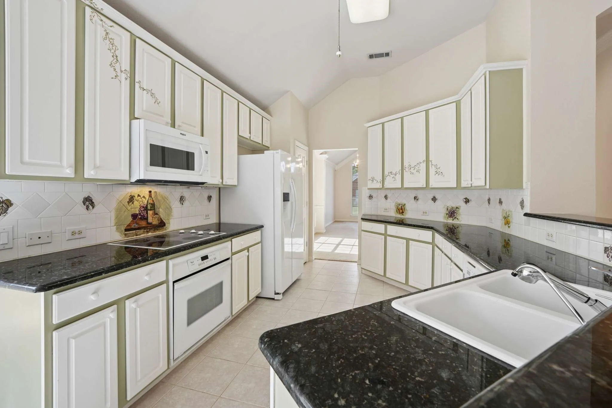 Gorgeous granite countertops with glass cooktop, oven and newer microwave oven.