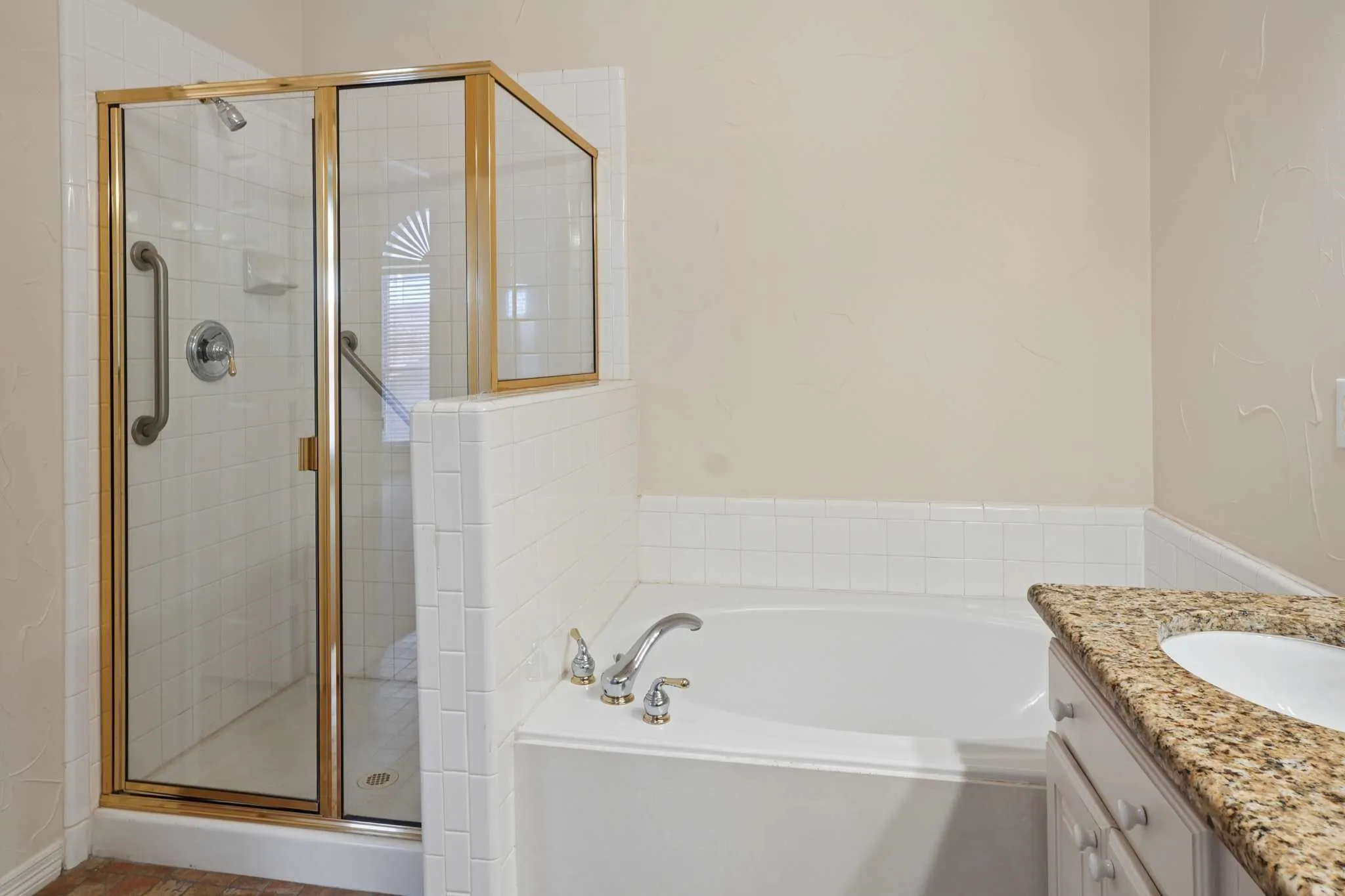 Primary bathroom has separate shower and large soaking tub.