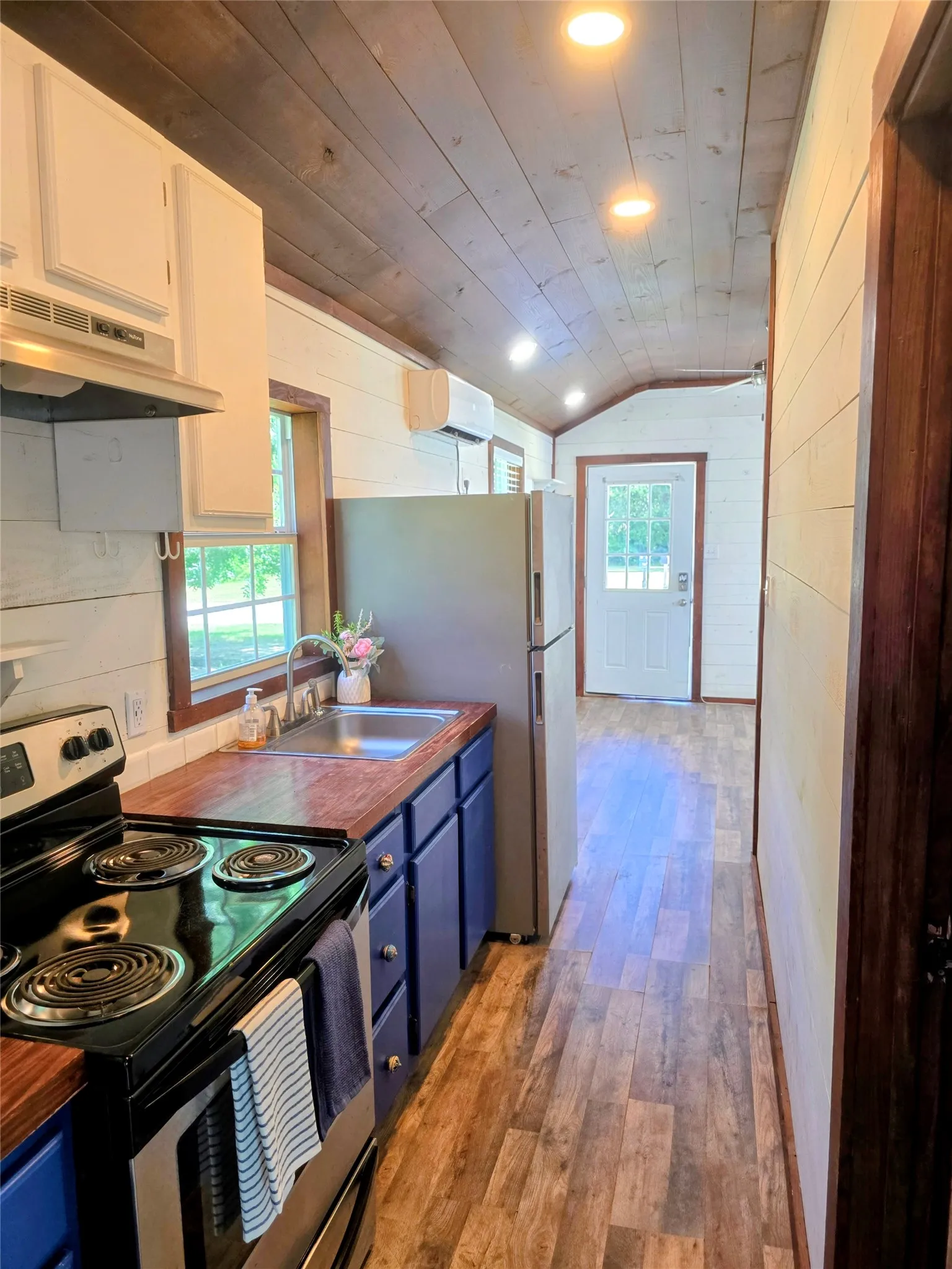 Kitchen featuring wood-finish flooring, wood plank ceiling, and recessed lighting
