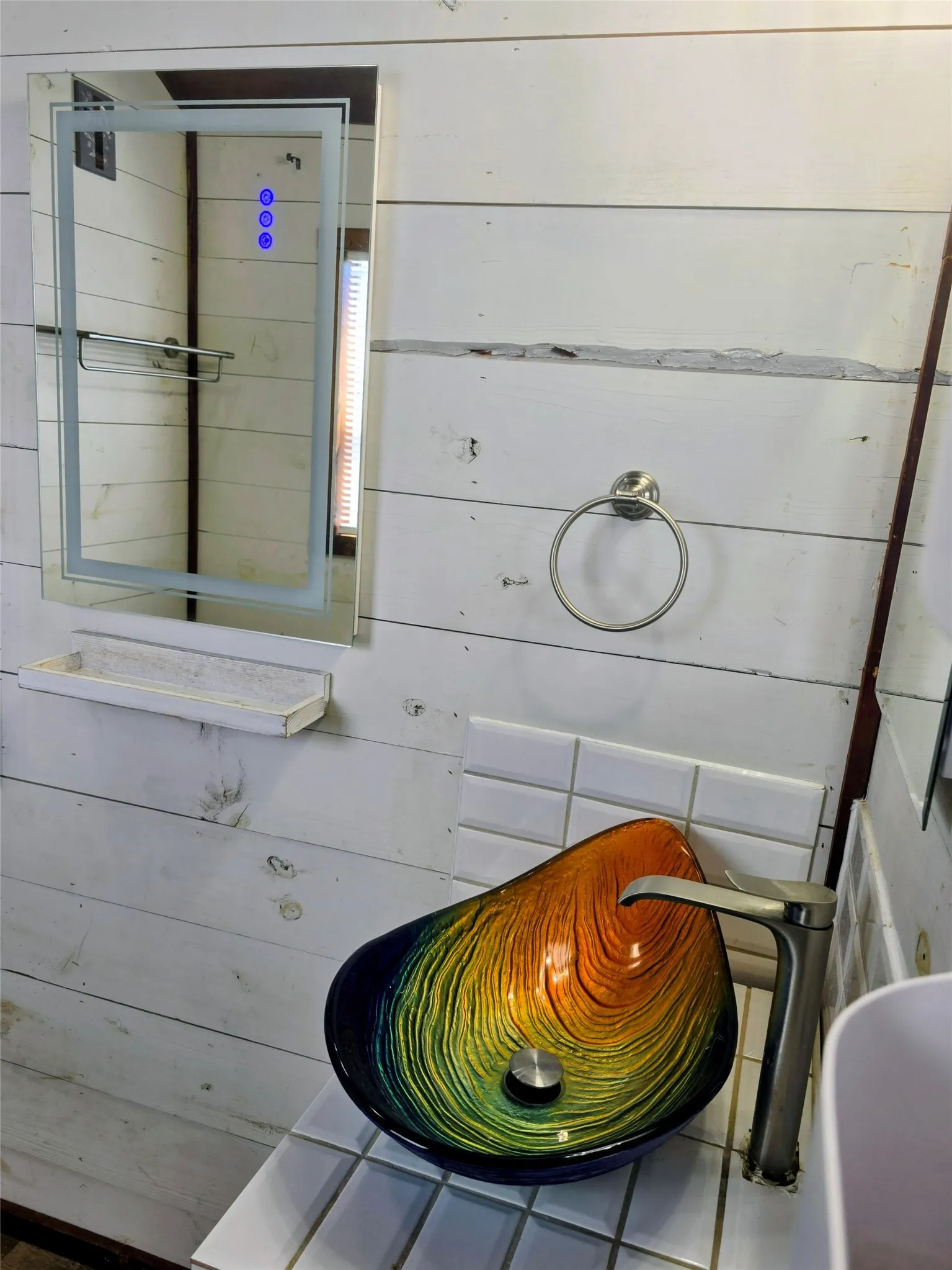 Vessel sink featuring an iridescent finish, complemented by a brushed nickel faucet, subway tile backsplash, and shiplap wall paneling