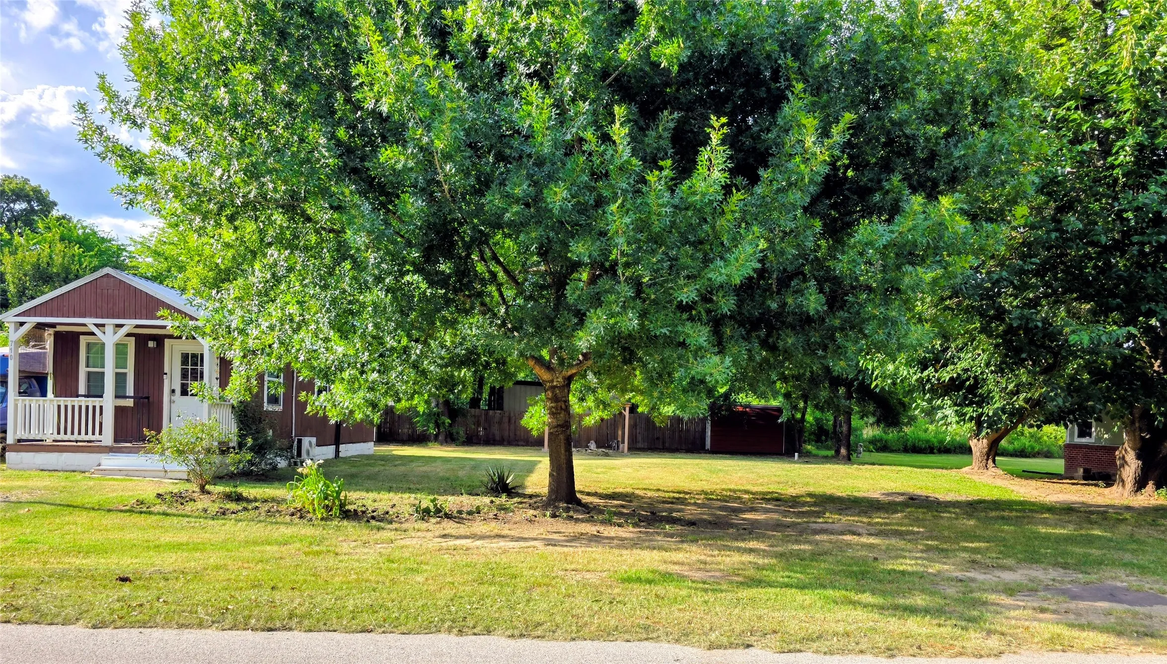 Expansive lawn with mature trees providing ample shade