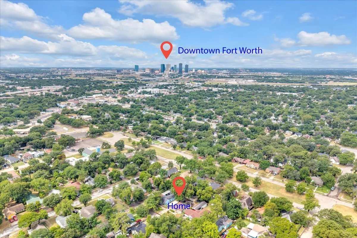 Aerial perspective showcasing a residential area with extensive tree coverage