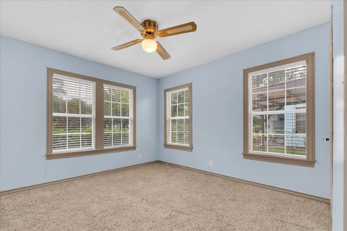 Room featuring light blue walls and neutral carpet flooring