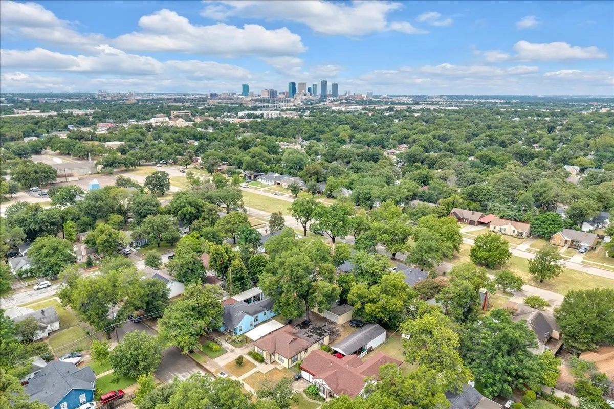 Aerial perspective showcasing a residential area with extensive mature tree canopy