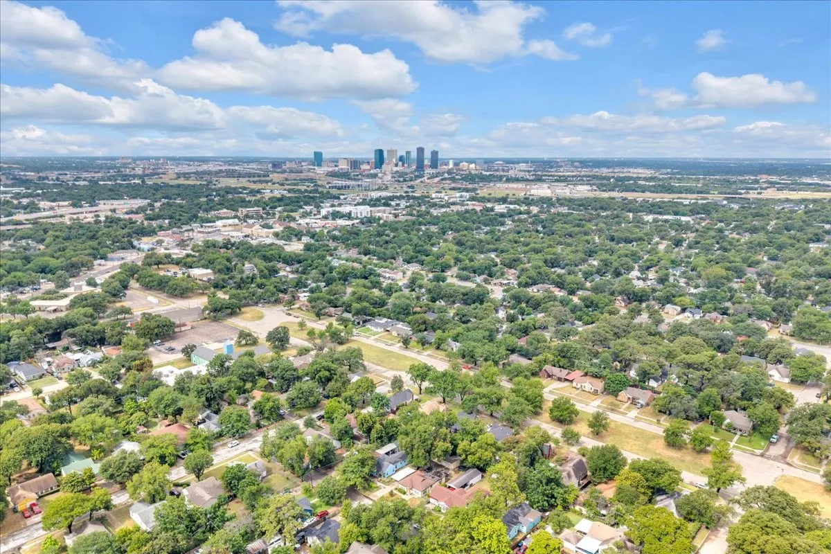 Aerial perspective showcasing a sprawling urban landscape with a distant city skyline