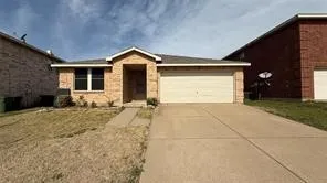 Single-story residence featuring a brick exterior with a front-facing garage