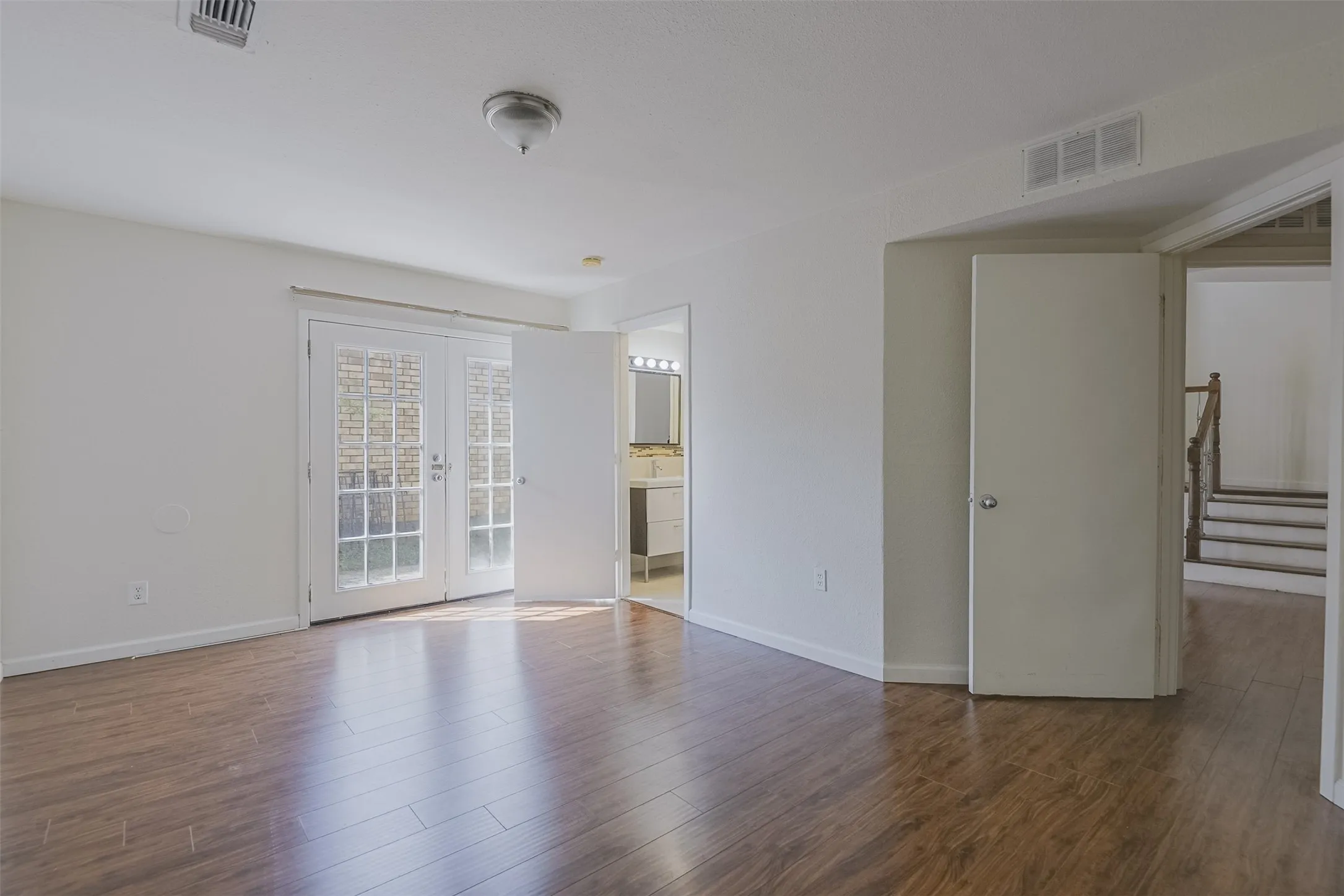 Spacious open floor plan with gleaming wood-finish flooring​​‌​​​​‌​​‌‌​‌‌​​​‌‌​‌​‌​‌​​​‌​​ throughout