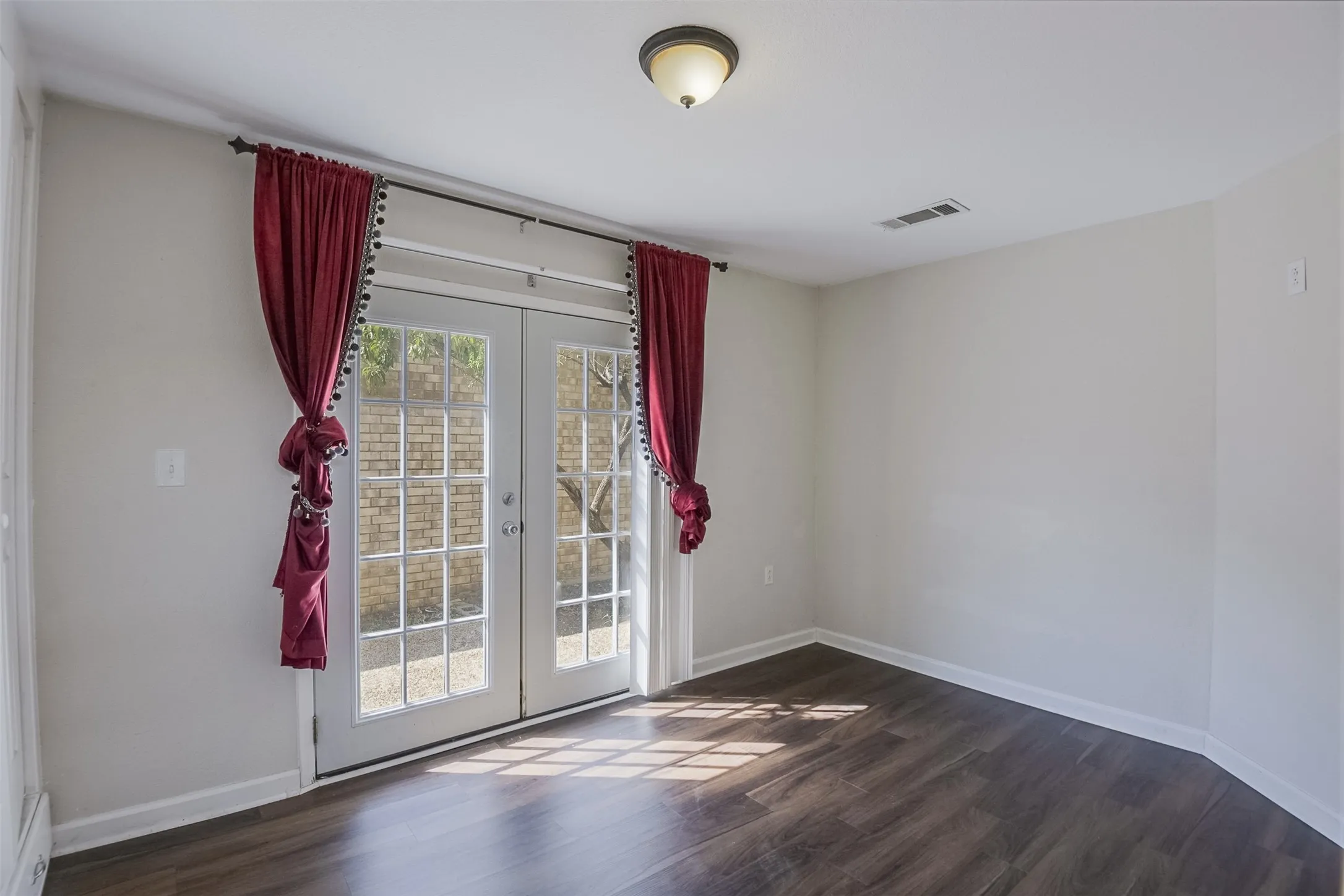 French doors with multiple lites, dark wood-finish flooring, recessed lighting, and light-colored walls