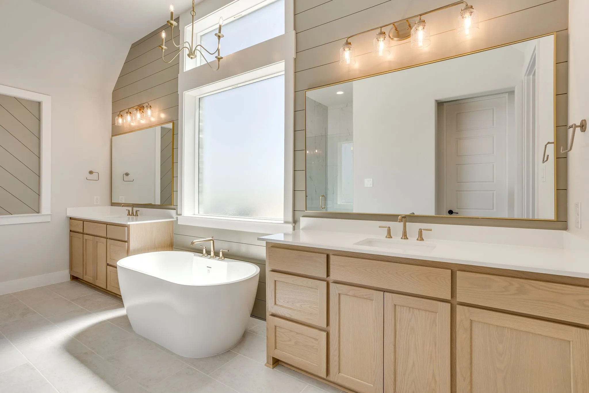 Freestanding soaking tub with gold-finish fixtures