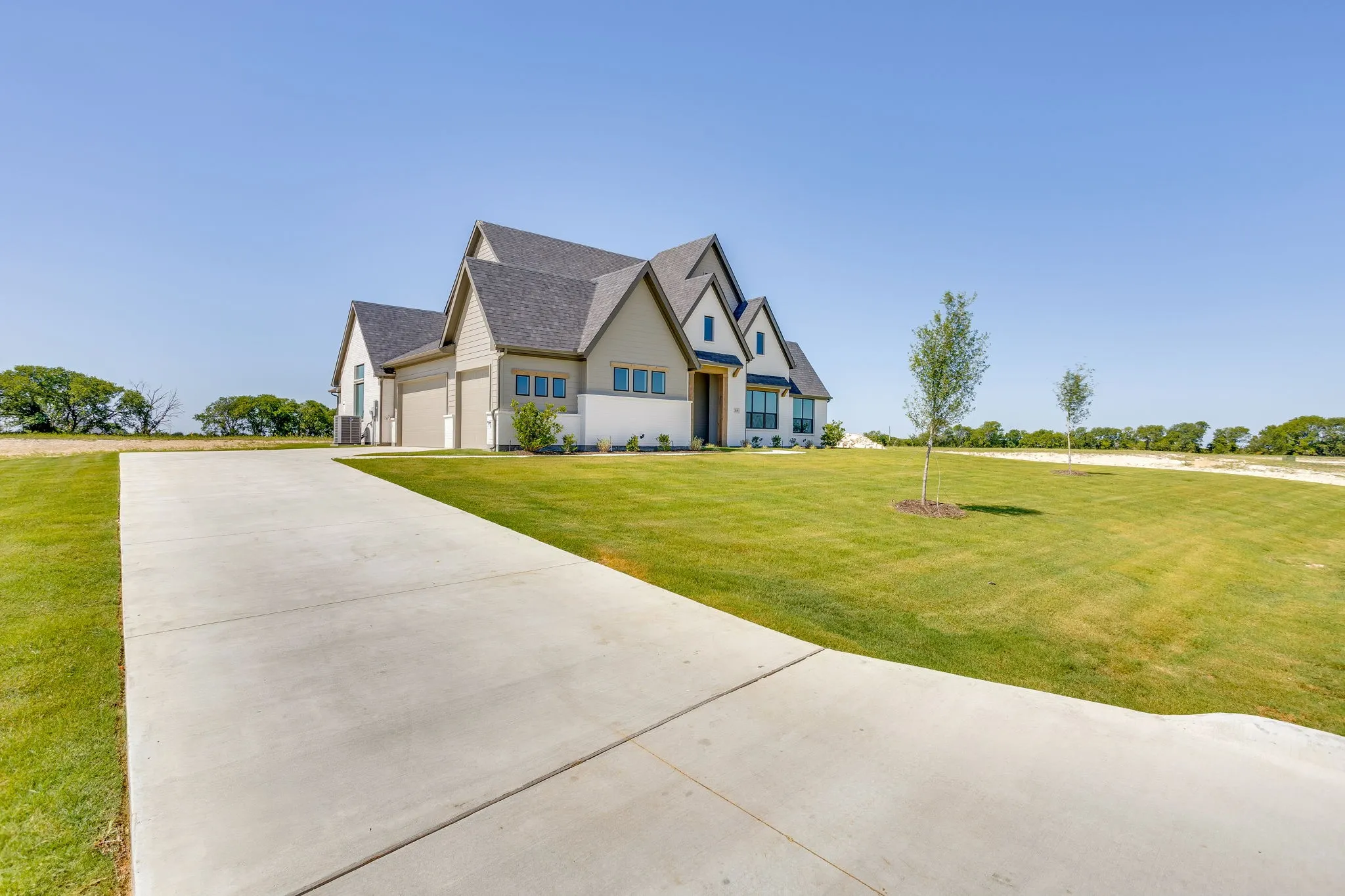 Contemporary-style home featuring a mixed-material facade with stone accents and horizontal siding