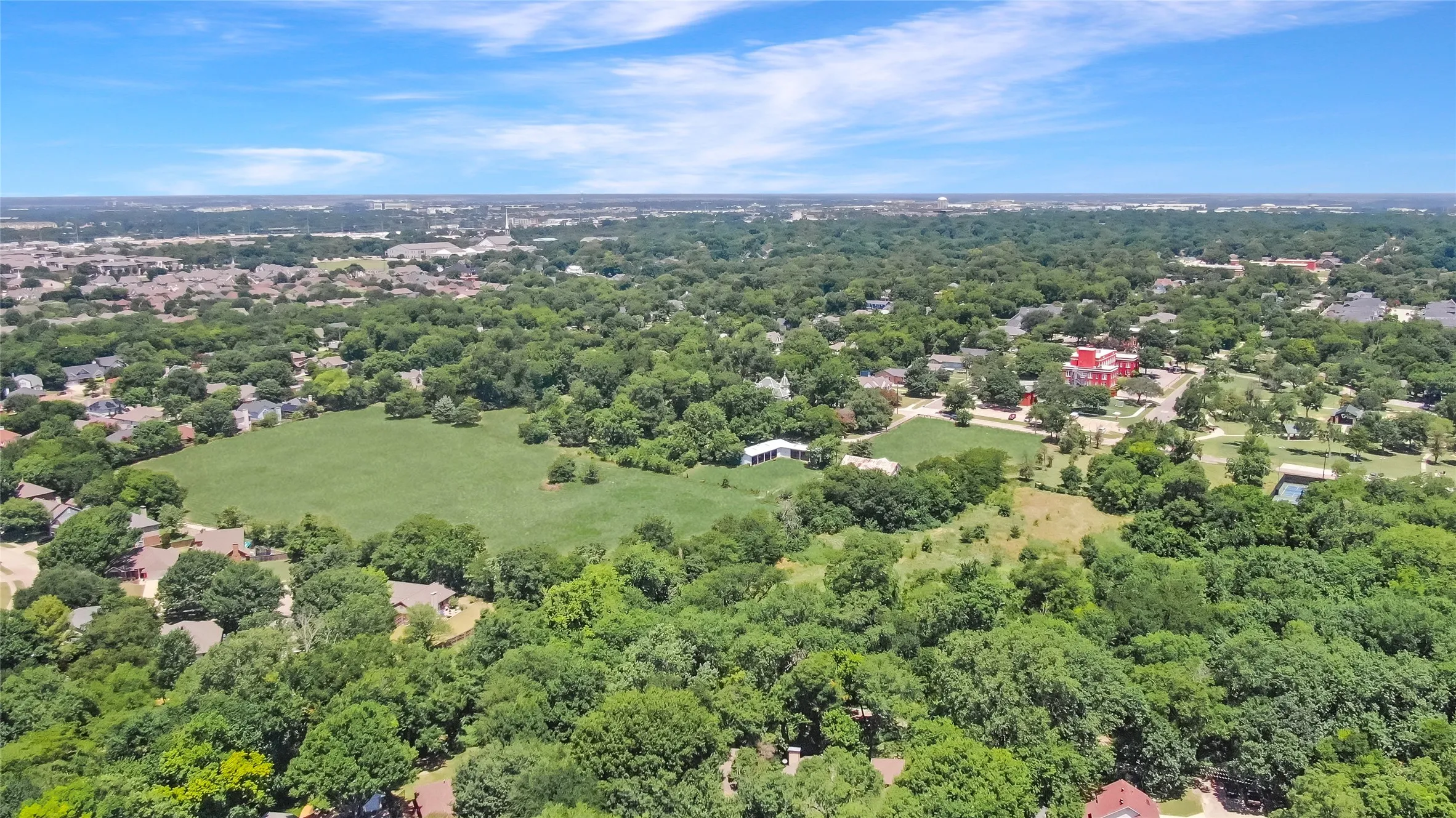 Expansive aerial view showcasing a verdant landscape with extensive tree canopy
