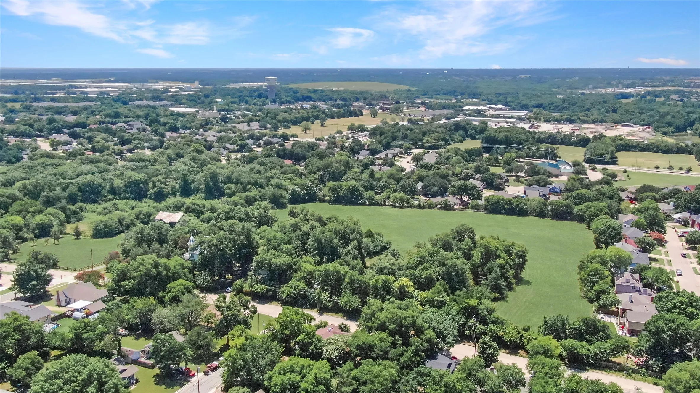 Aerial perspective showcasing a verdant landscape with extensive tree coverage