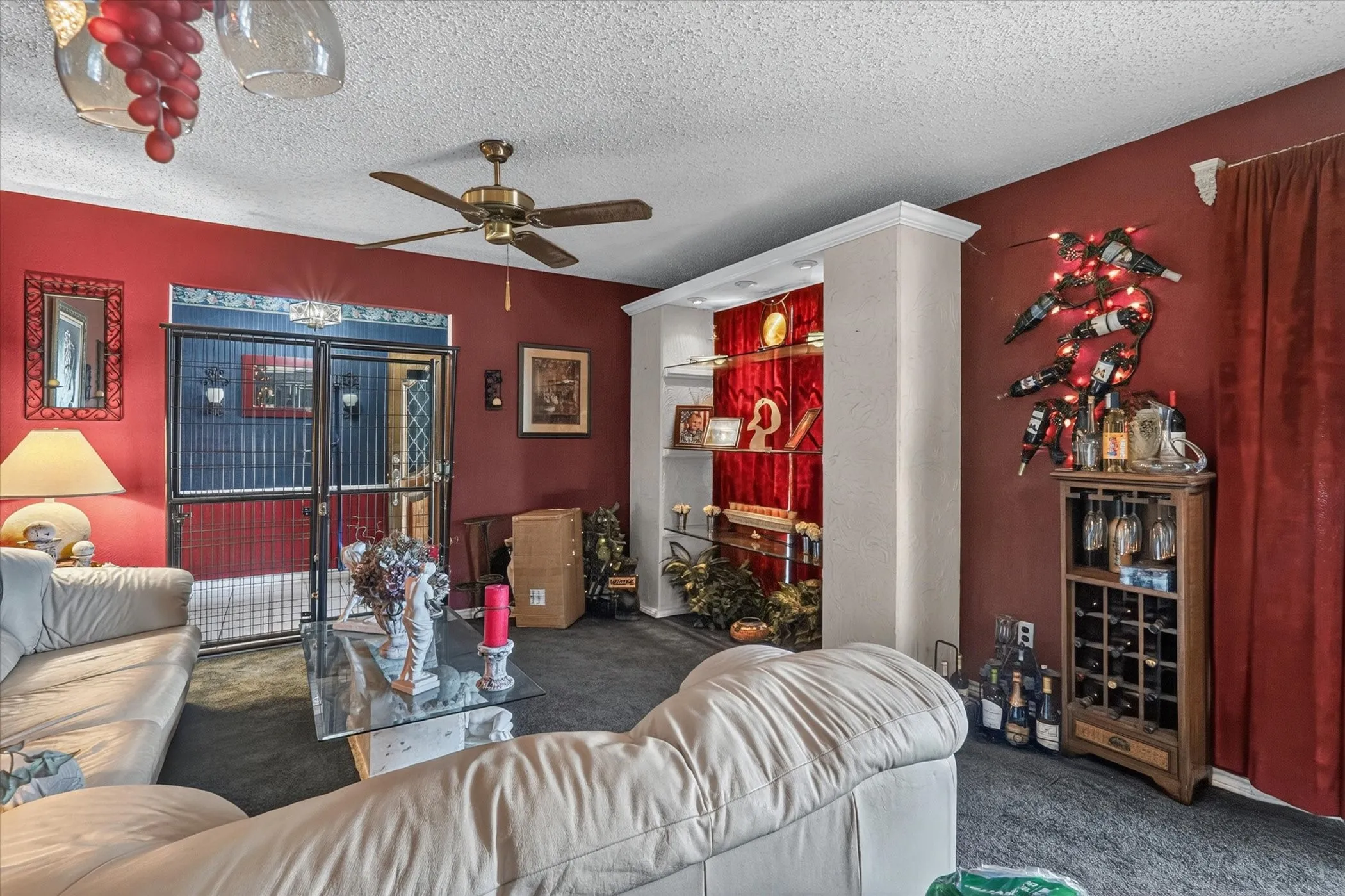Interior space featuring textured ceiling, a ceiling fan with integrated lighting, and carpet flooring