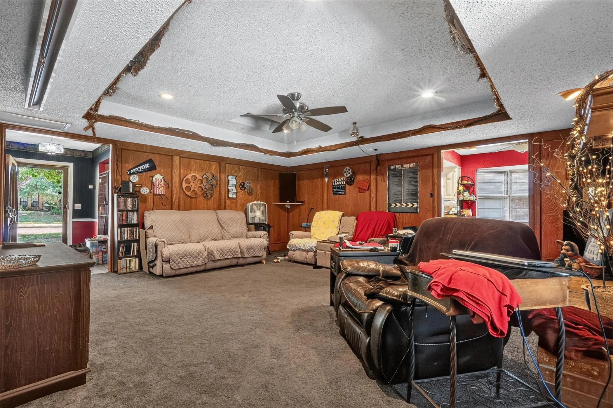 Spacious interior featuring wood paneling, recessed lighting, and a ceiling fan