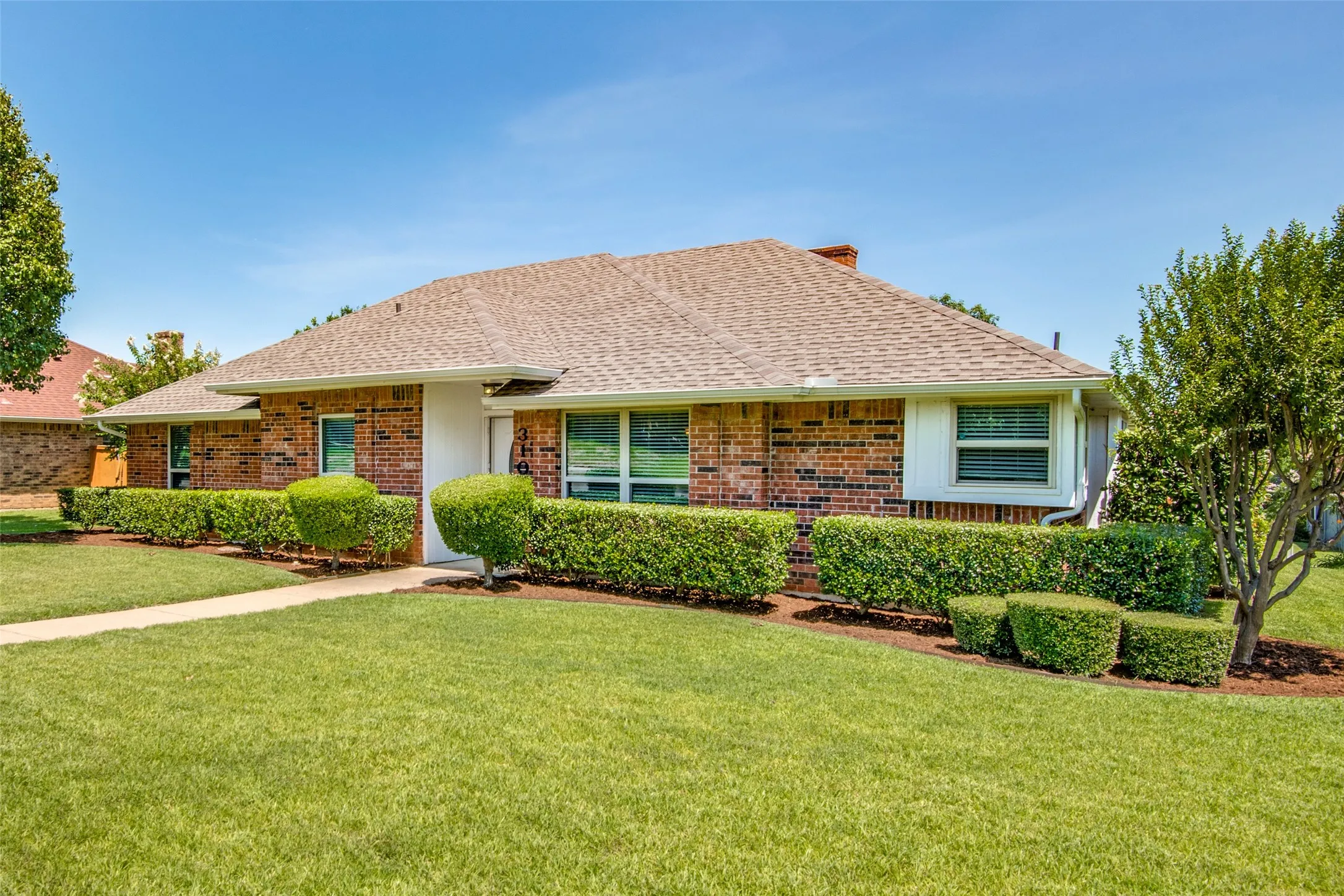 Brick exterior with a gabled roof and white trim