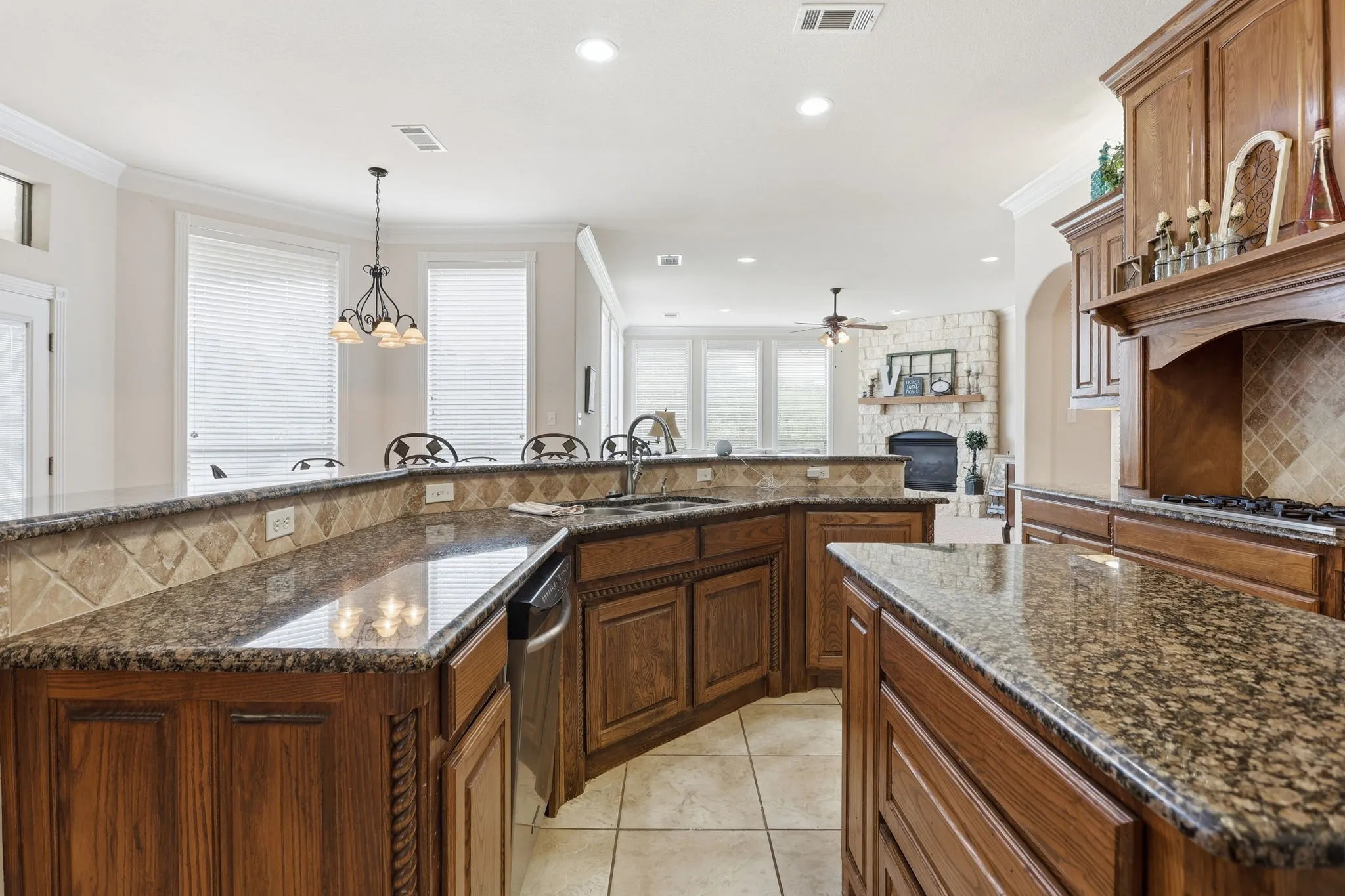 Kitchen featuring granite countertops, wood cabinetry, tile flooring, and a tile backsplash