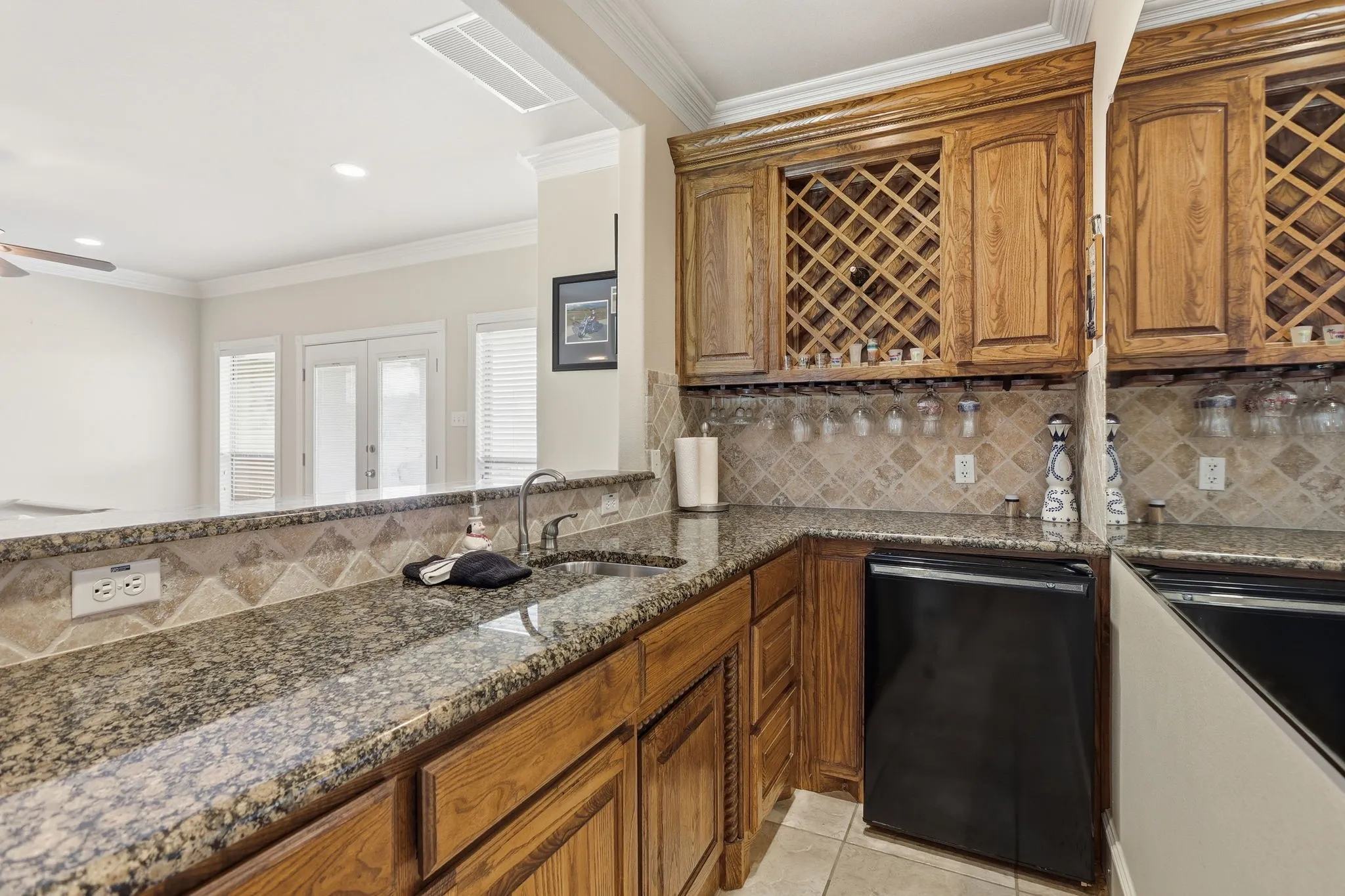 wet bar area with mini fridge and sink