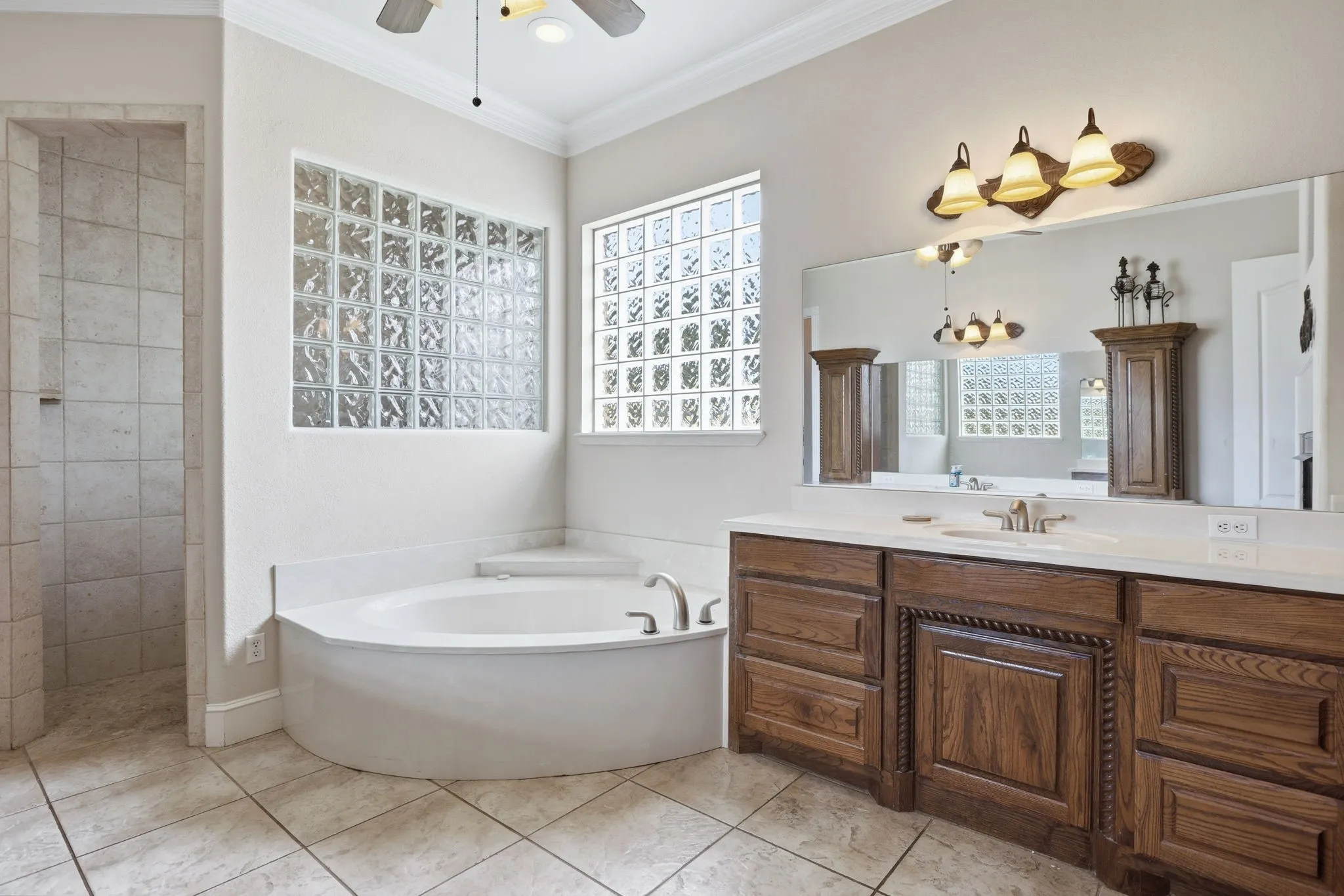 Corner garden tub with surrounding glass block windows
