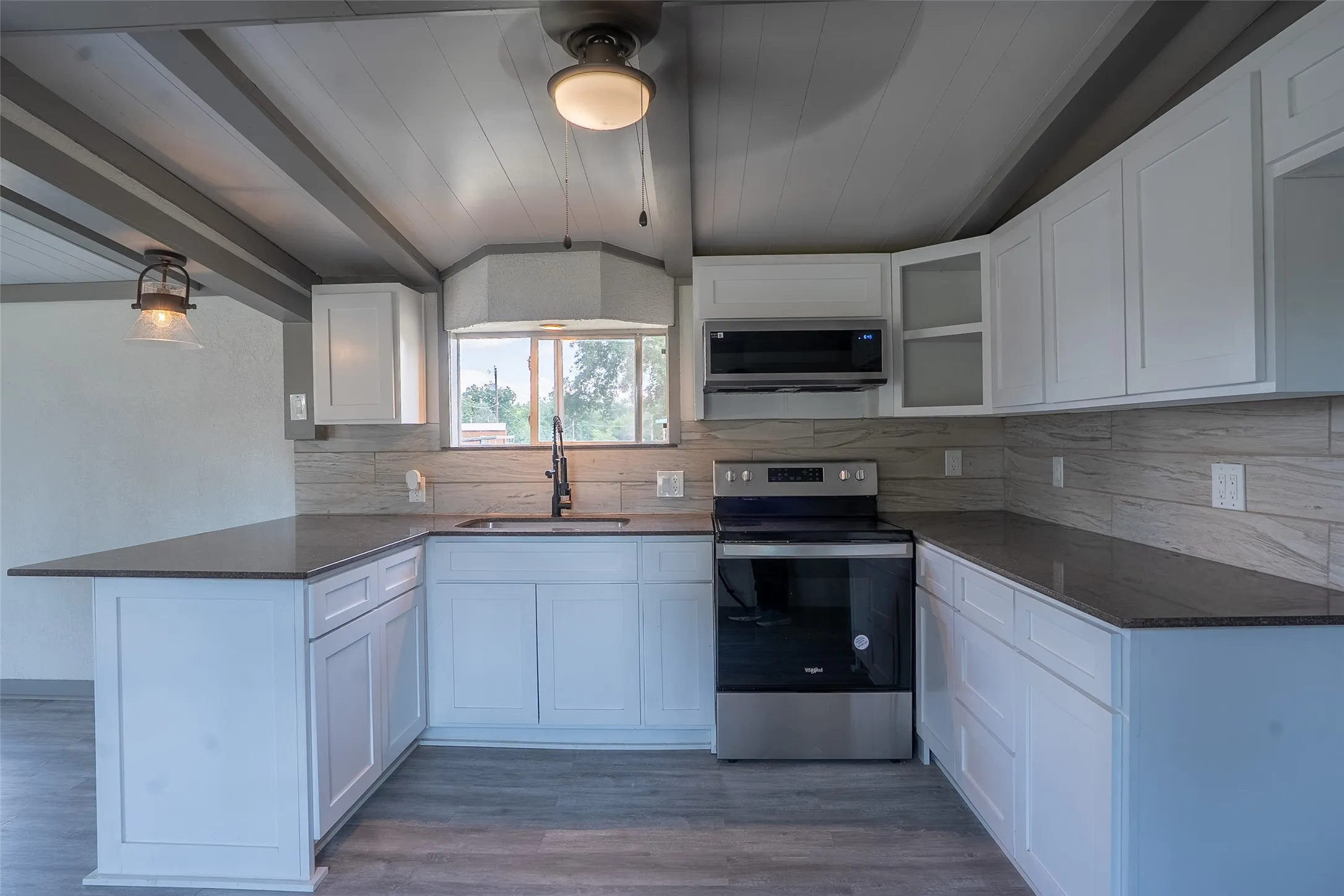 White shaker cabinetry with dark countertops