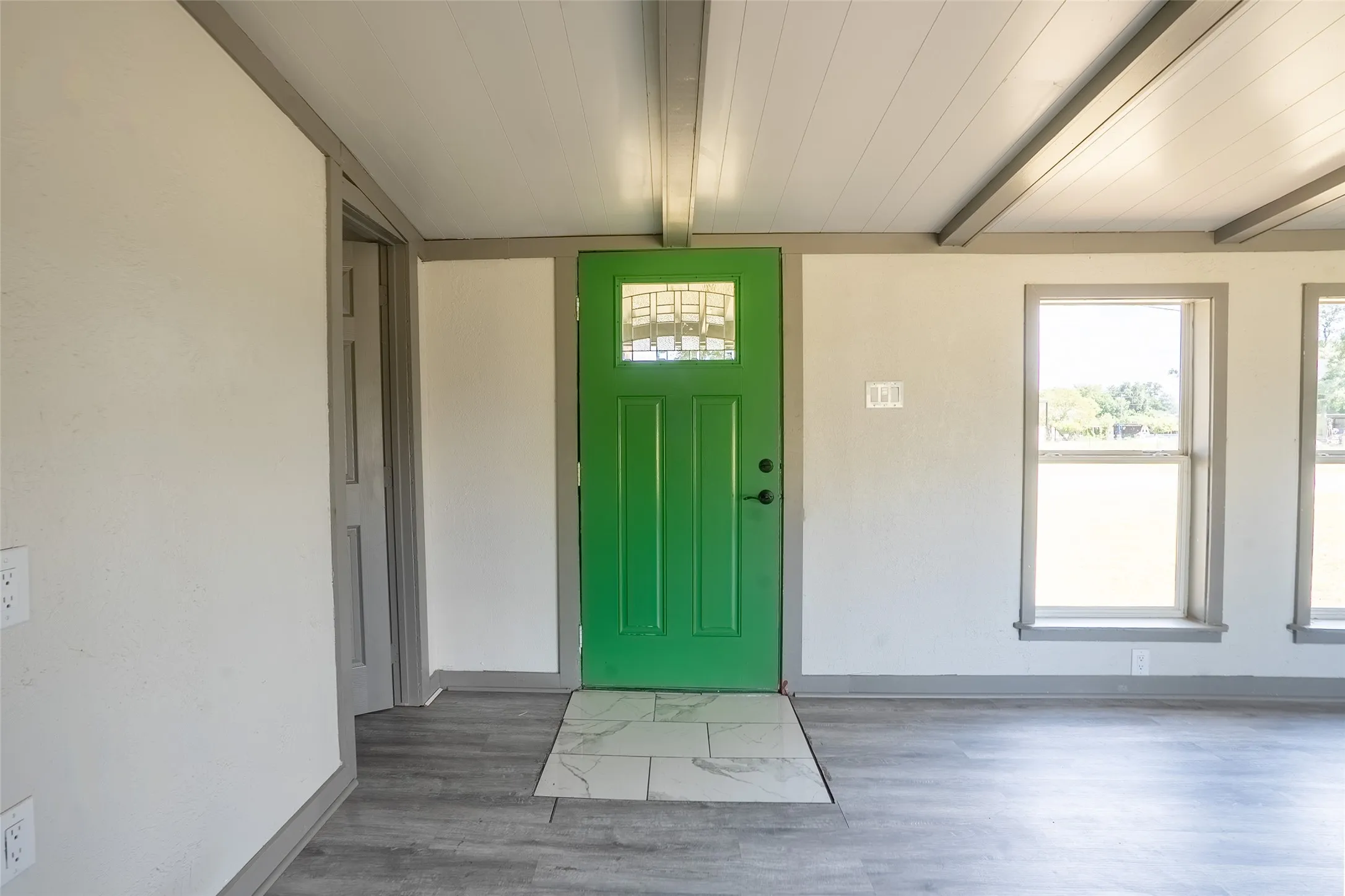 Vibrant green entry door with decorative glass inserts
