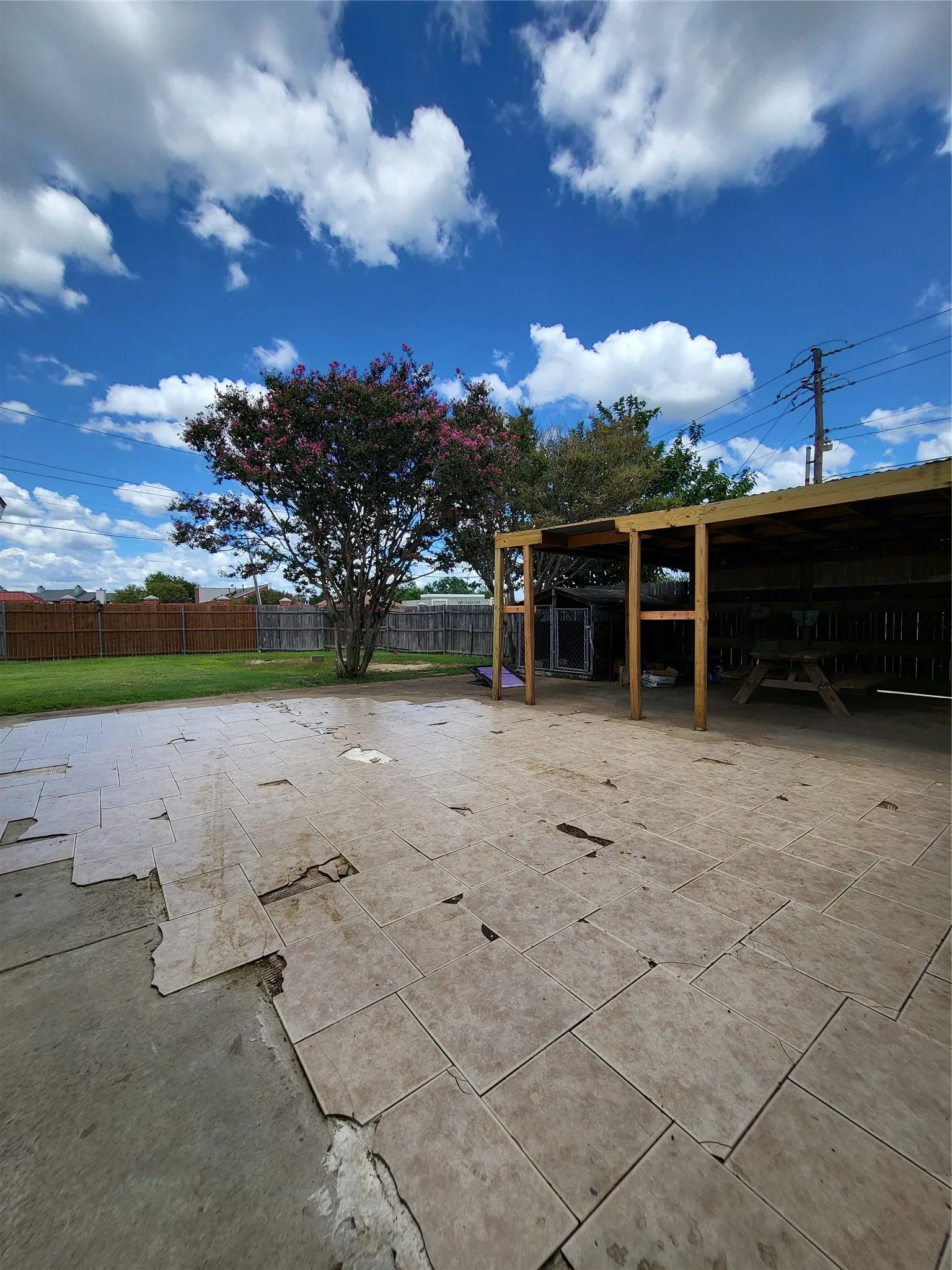 Expansive outdoor area featuring covered patio and outdoor kennel