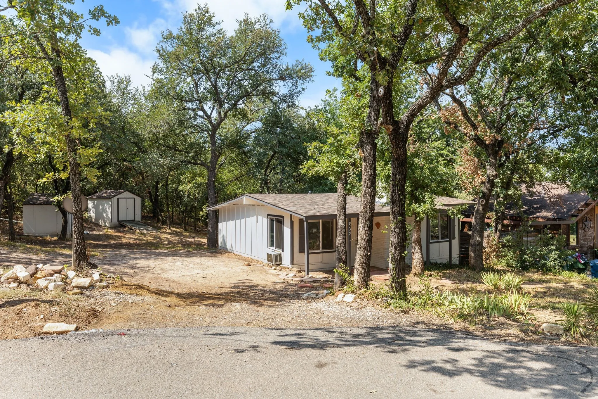 Wooded lot with mature oak and pine trees providing natural shade and privacy