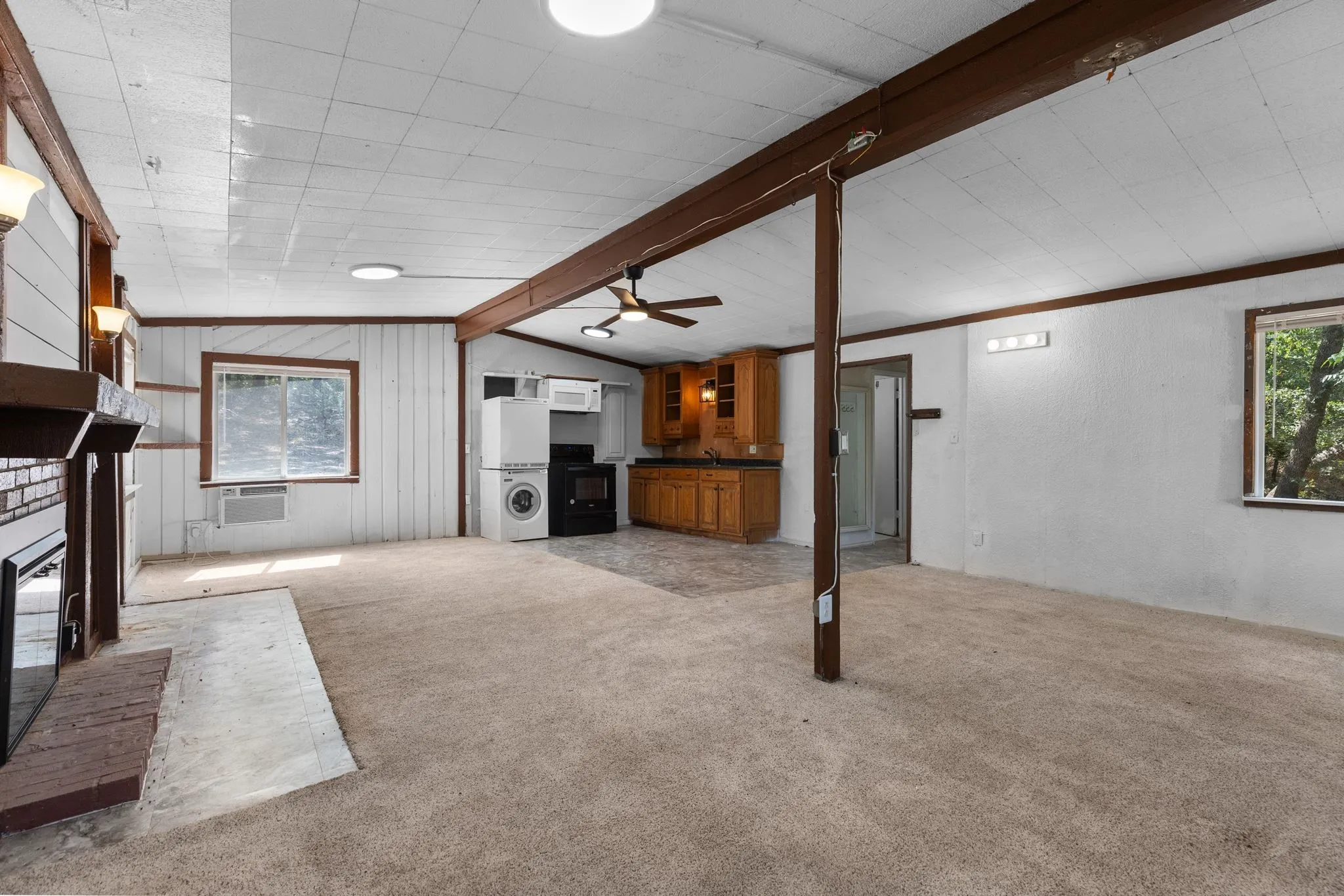Exposed wood beams and a brick fireplace