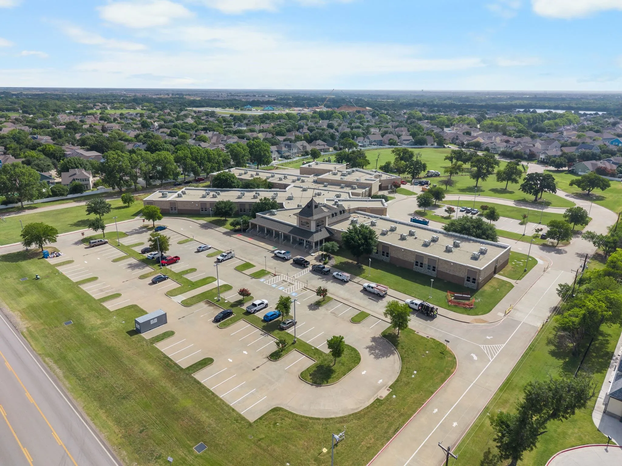 Aerial perspective of a large institutional building featuring multiple wings and a prominent central entrance