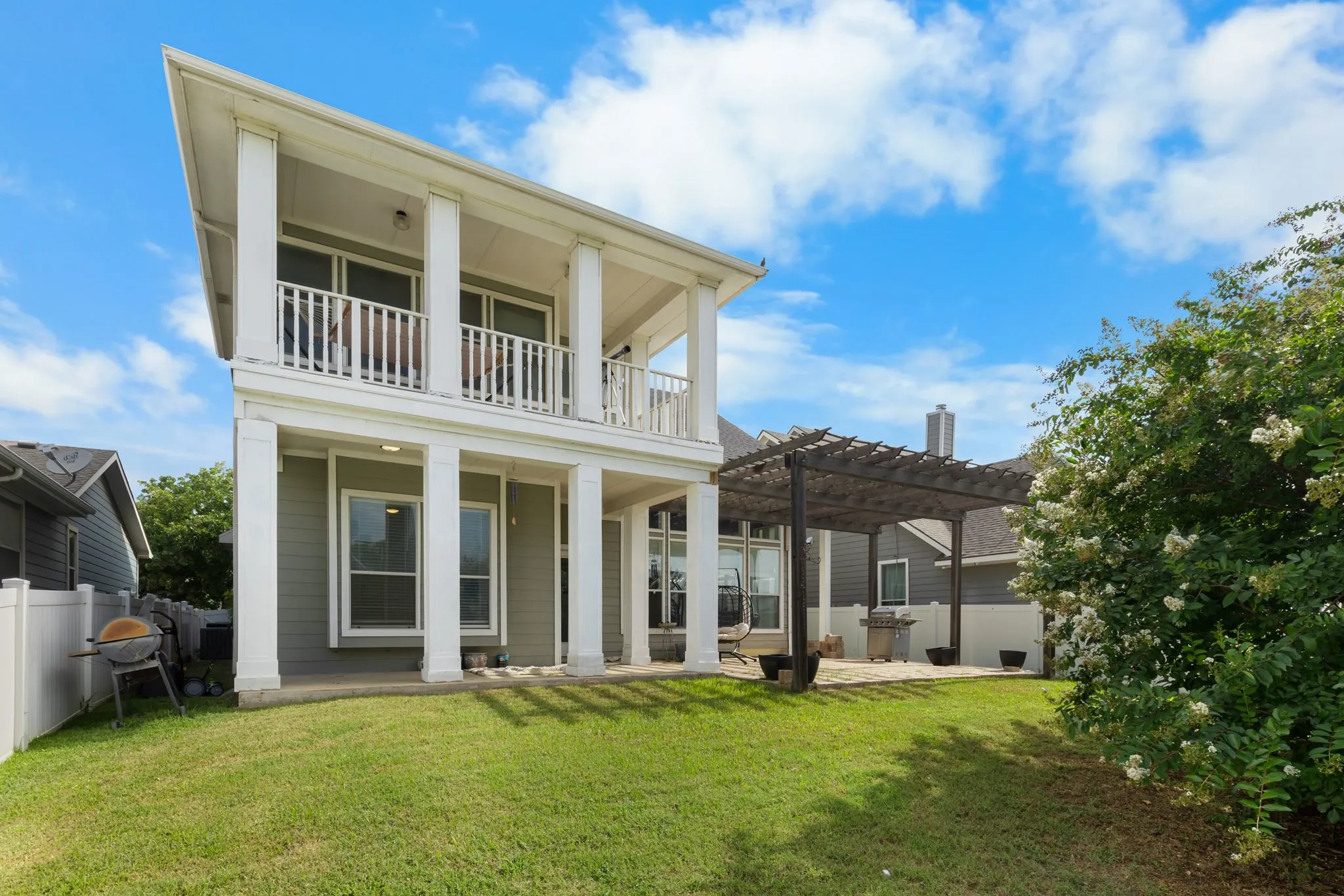 Two-story exterior with a ground-level patio and an upper-level balcony