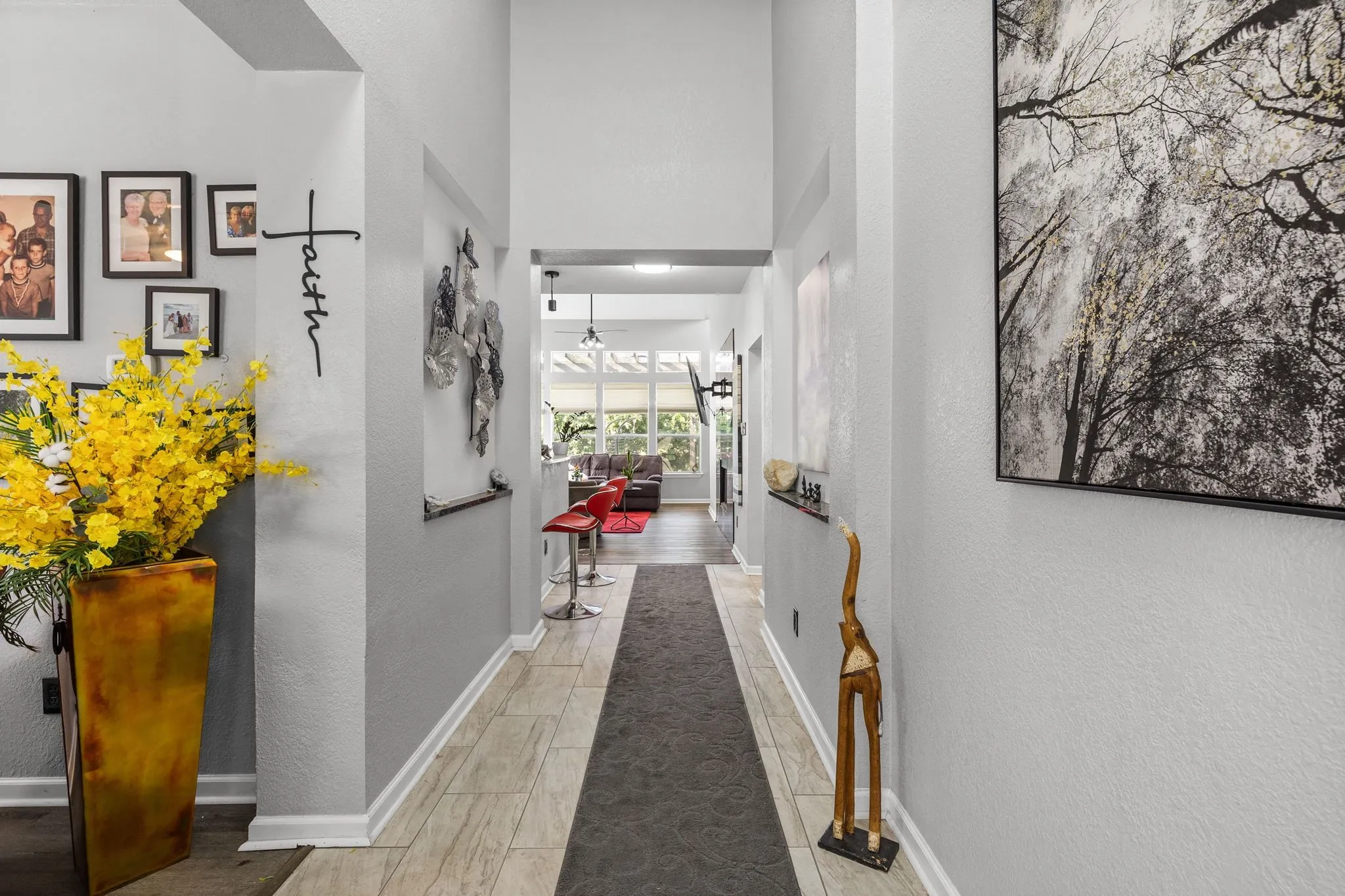Bright hallway featuring a vaulted ceiling and light wood-finish flooring