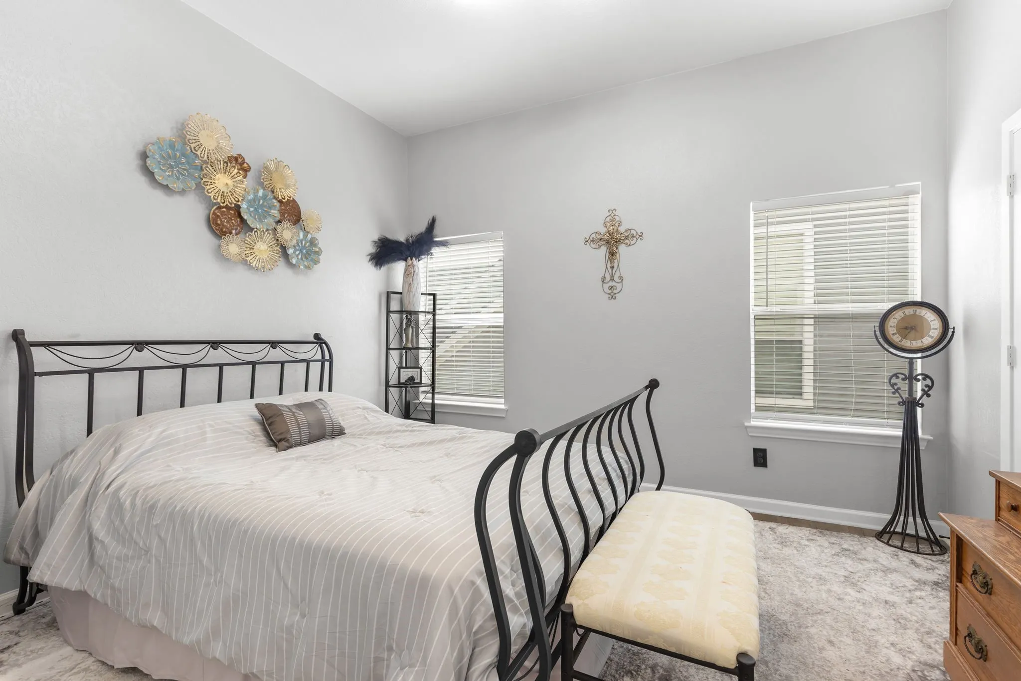 Spacious interior featuring two windows with blinds, a prominent ceiling light fixture, and light-toned wall finishes