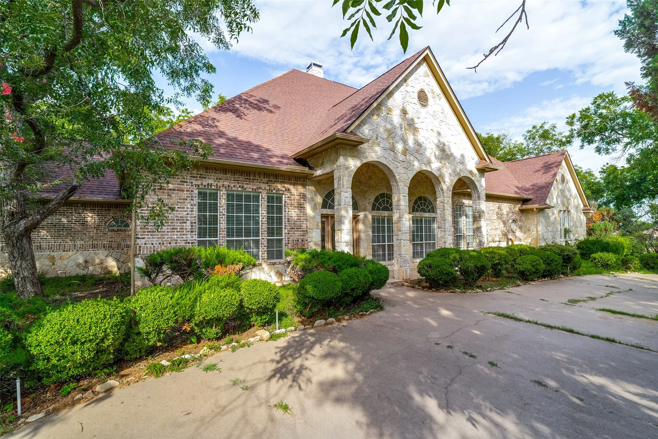 Stone and brick exterior featuring a arched entry