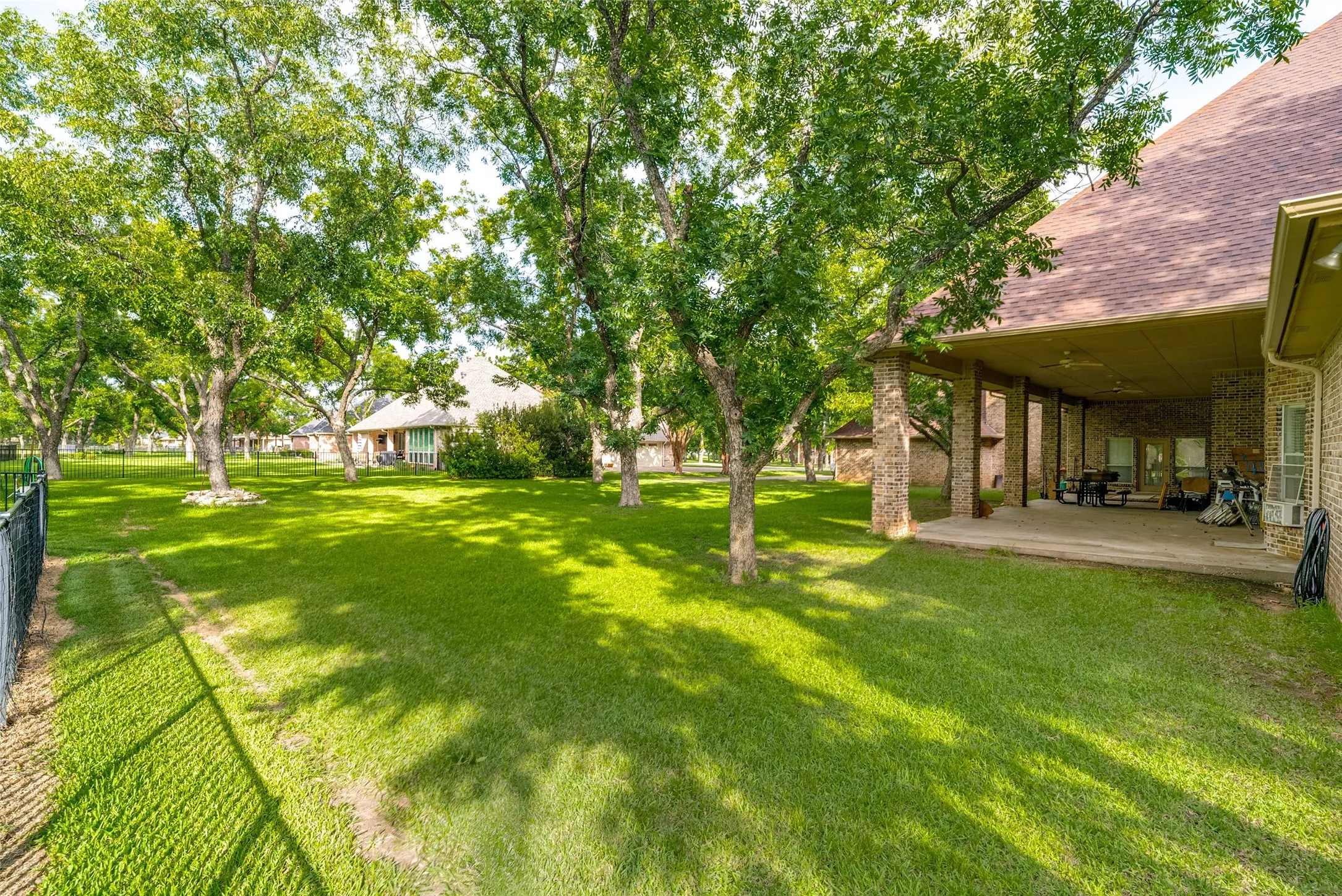 Spacious backyard, mature trees, and a exlarge covered patio