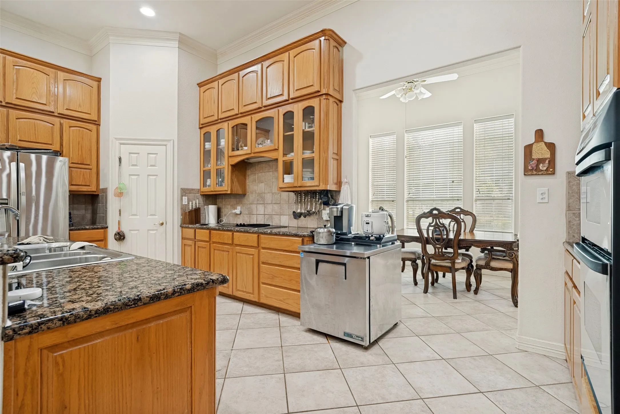 open kitchen with custom cabinetry, walk-in pantry