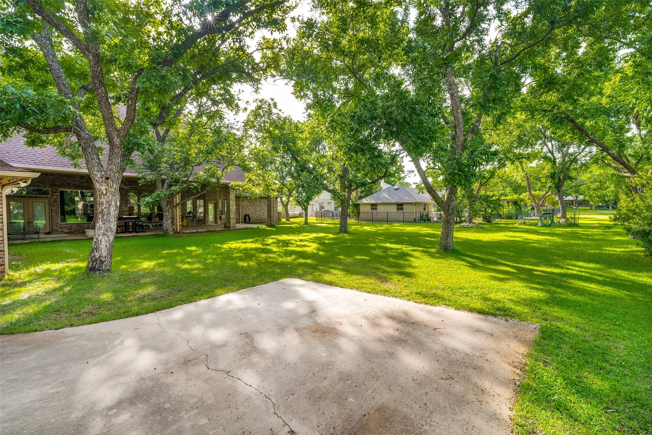 Golf course view, expansive green lawn with mature trees